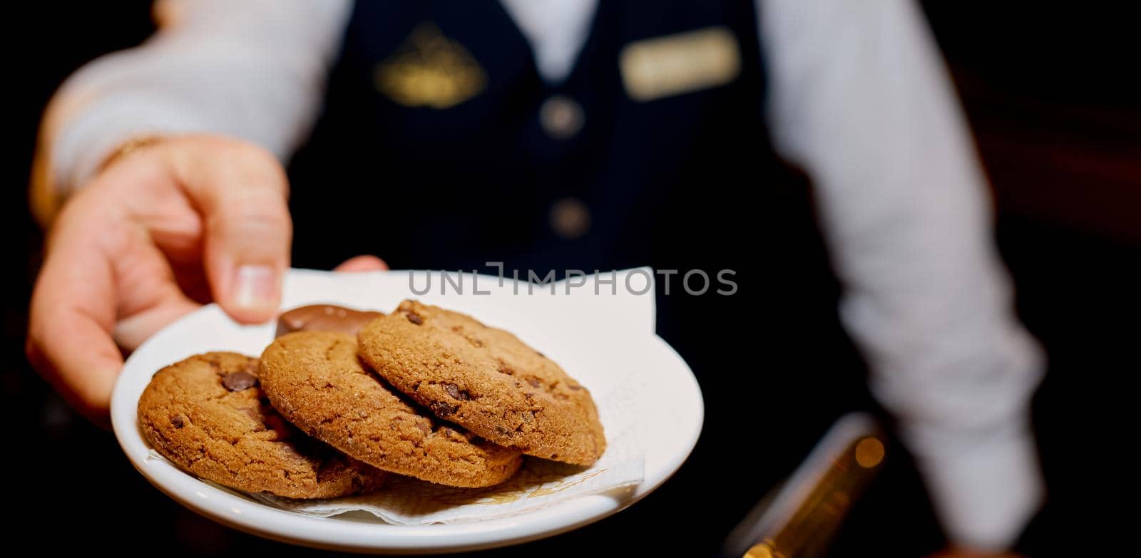 man water holding bowl with delicious cookies, closeup by AntonIlchanka