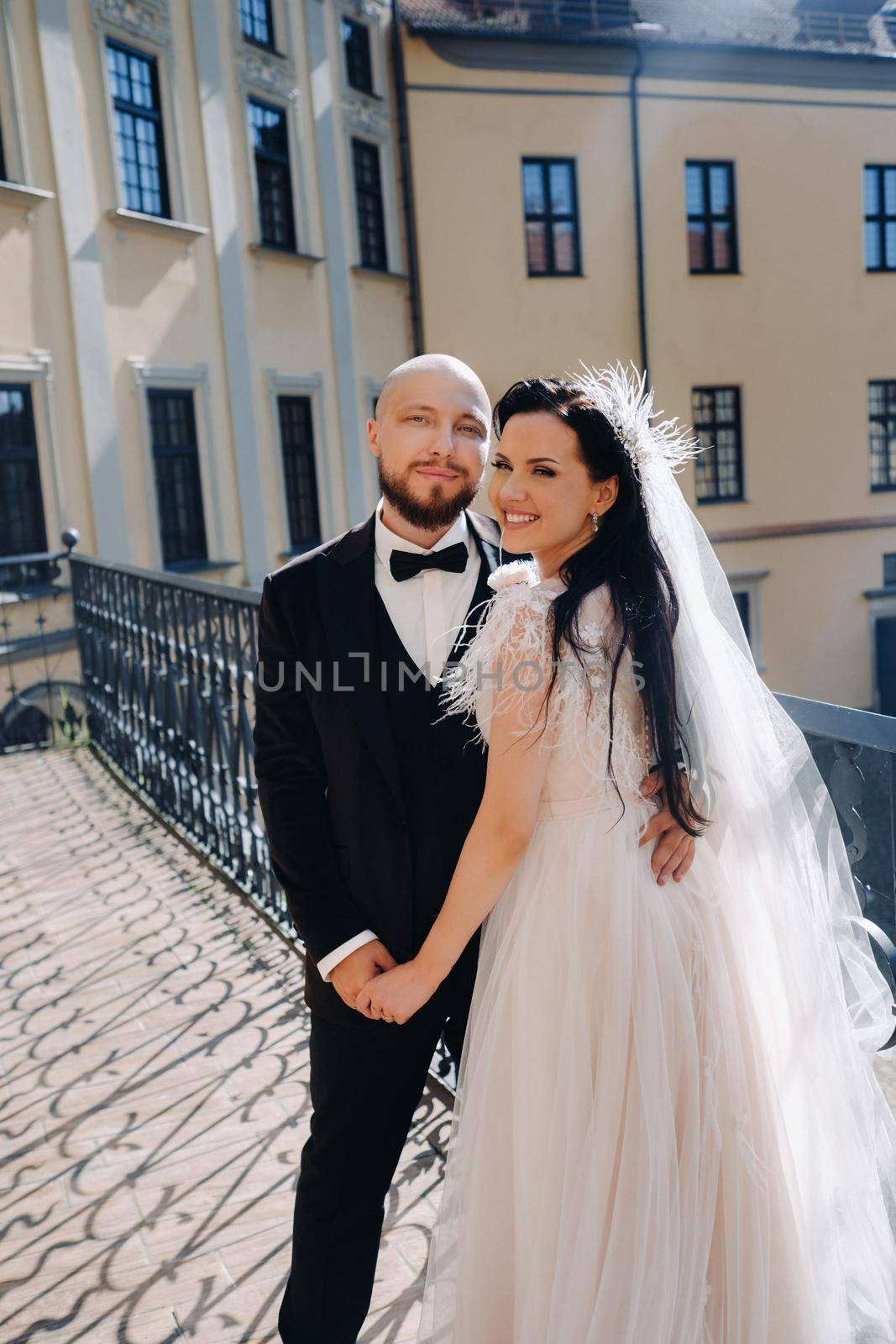 Elegant wedding couple on the balcony of an old castle in the city of Nesvizh.