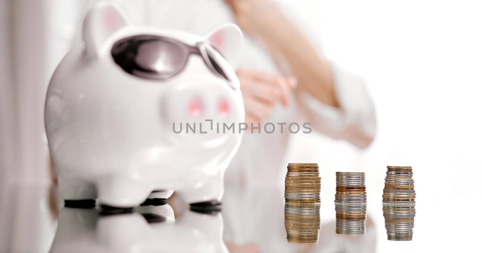 Businesswoman With Piggybank And Stack Of Coins. High quality photo