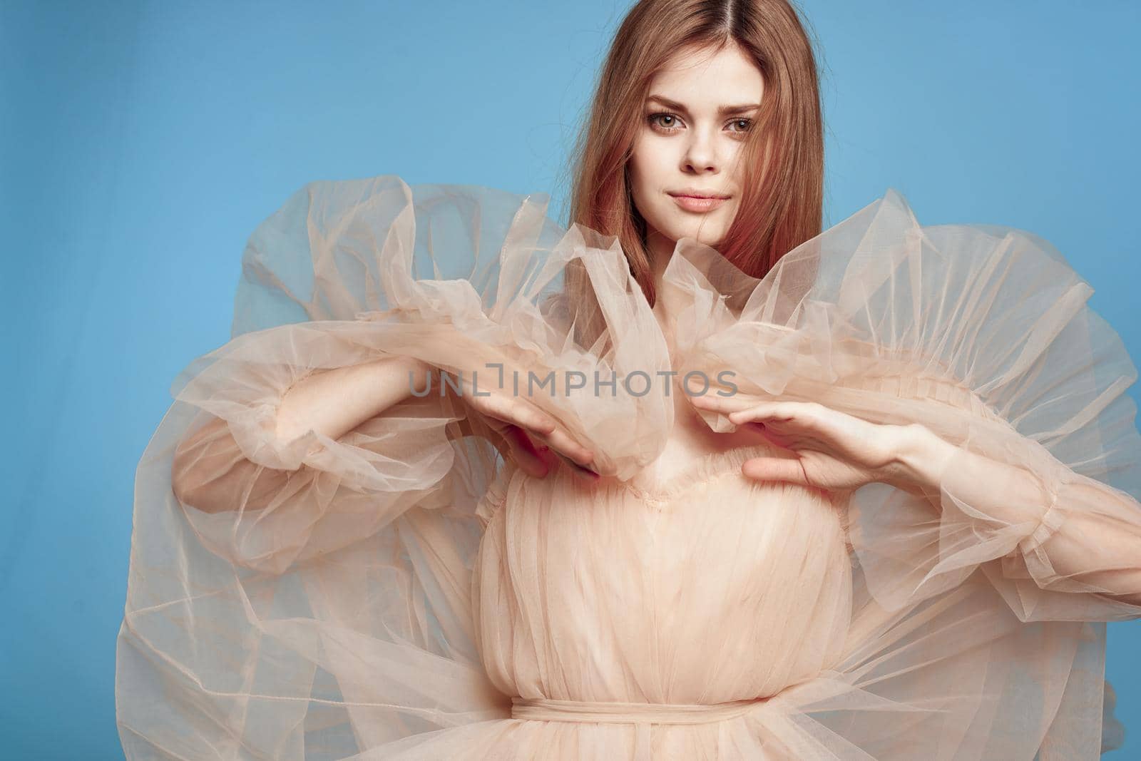 portrait of a woman in beige dress posing charm model studio. High quality photo