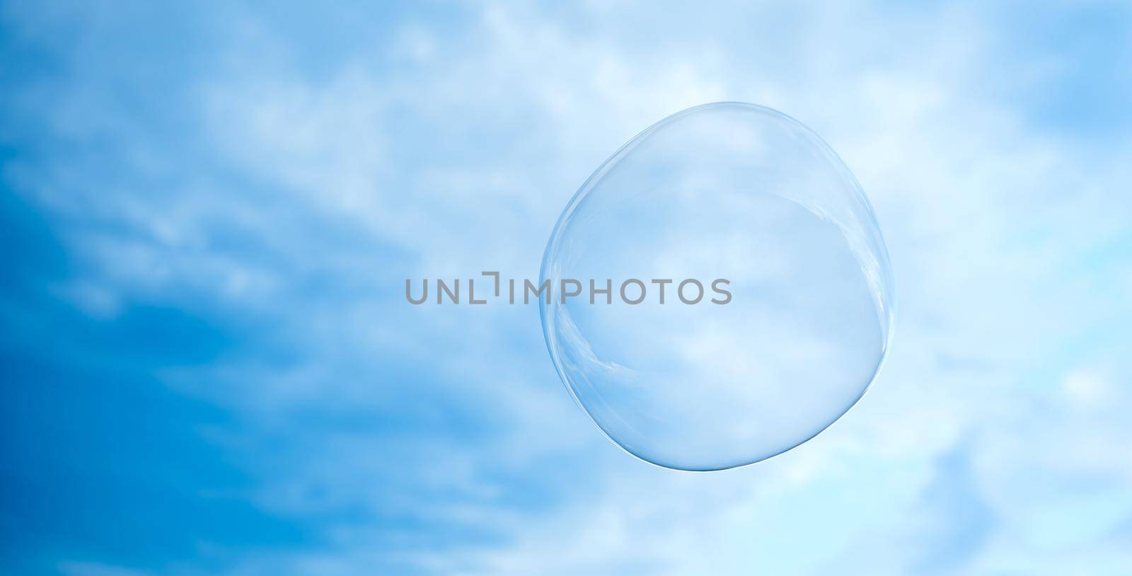 big soap bubble. The sky is light cloudy. by AntonIlchanka