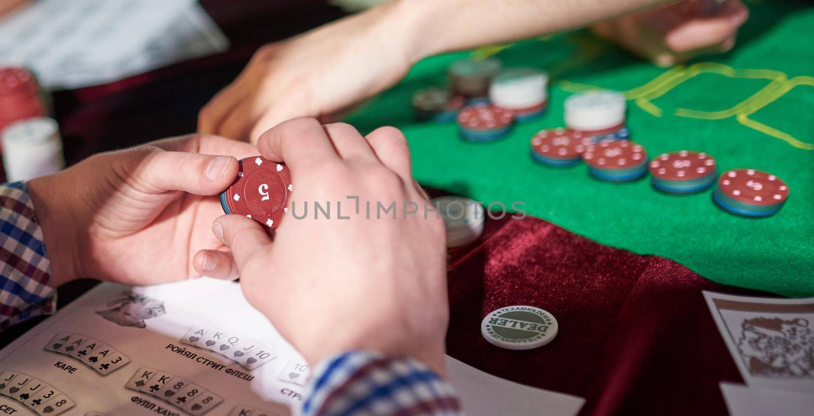 man prepare place bet with poker chips on green table. High quality photo