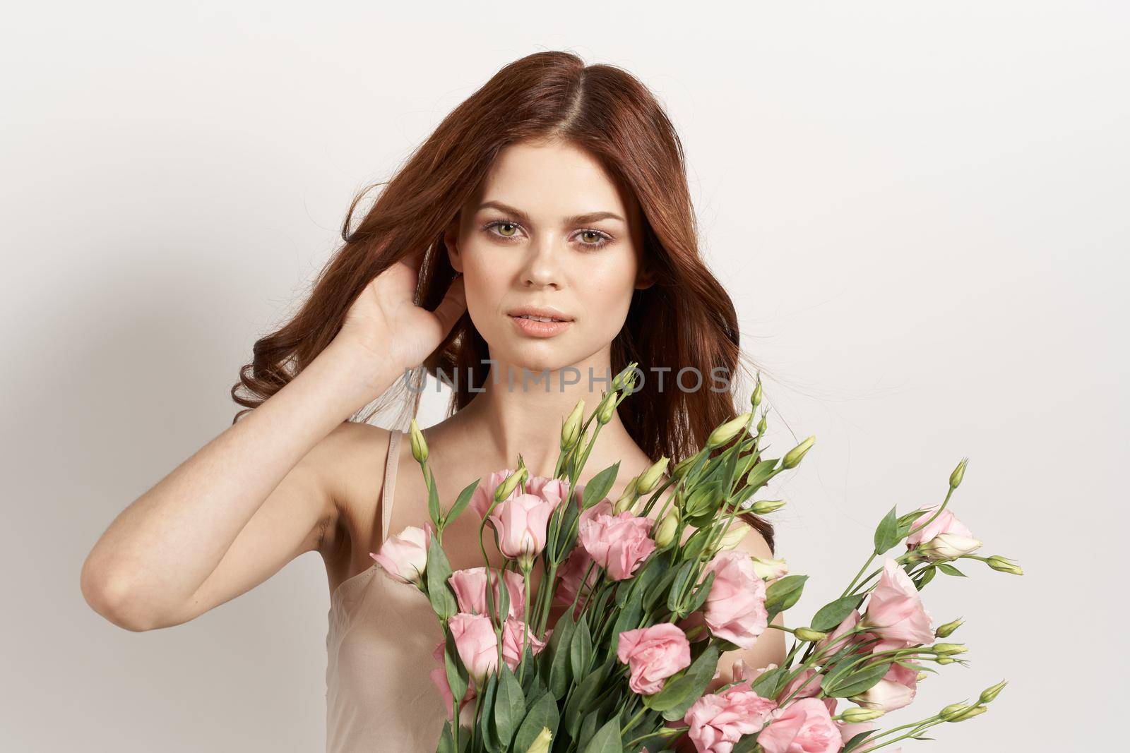 attractive woman with a bouquet of flowers isolated background. High quality photo