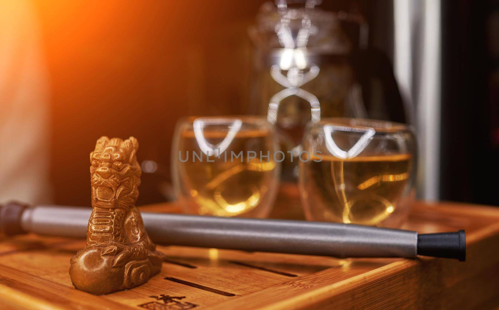 Chinese traditional tea tray with dragon in the foreground, hookah tube and kettle cups. High quality photo