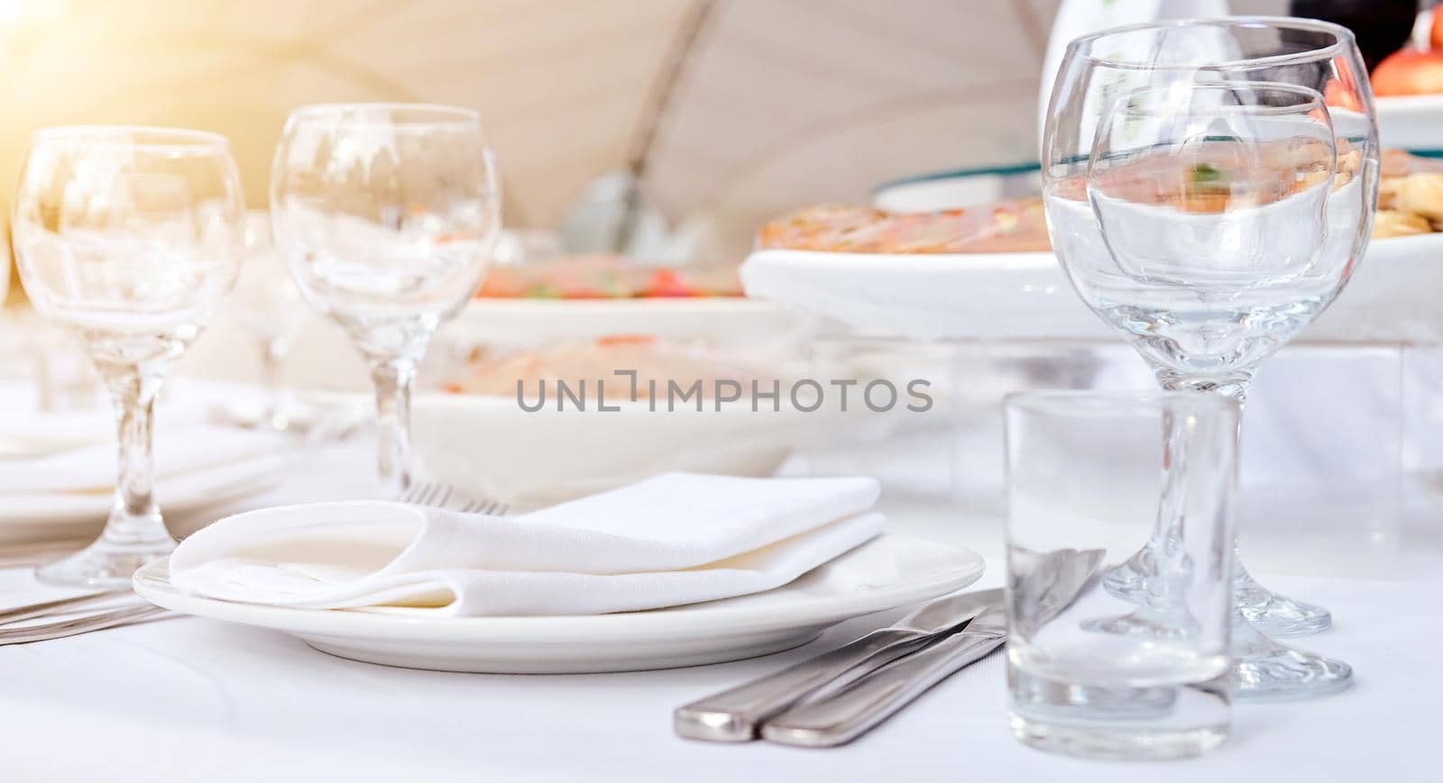 Beautiful festive table of luxury plates, glasses and cutlery served for wine tasting. Close up, blur background. High quality photo