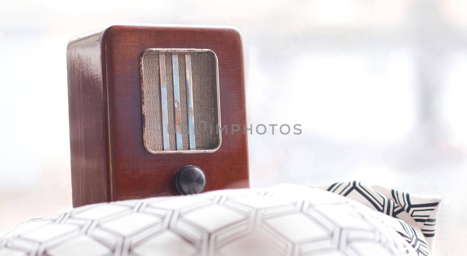 old shabby retro radio stands on a pillow . High quality photo