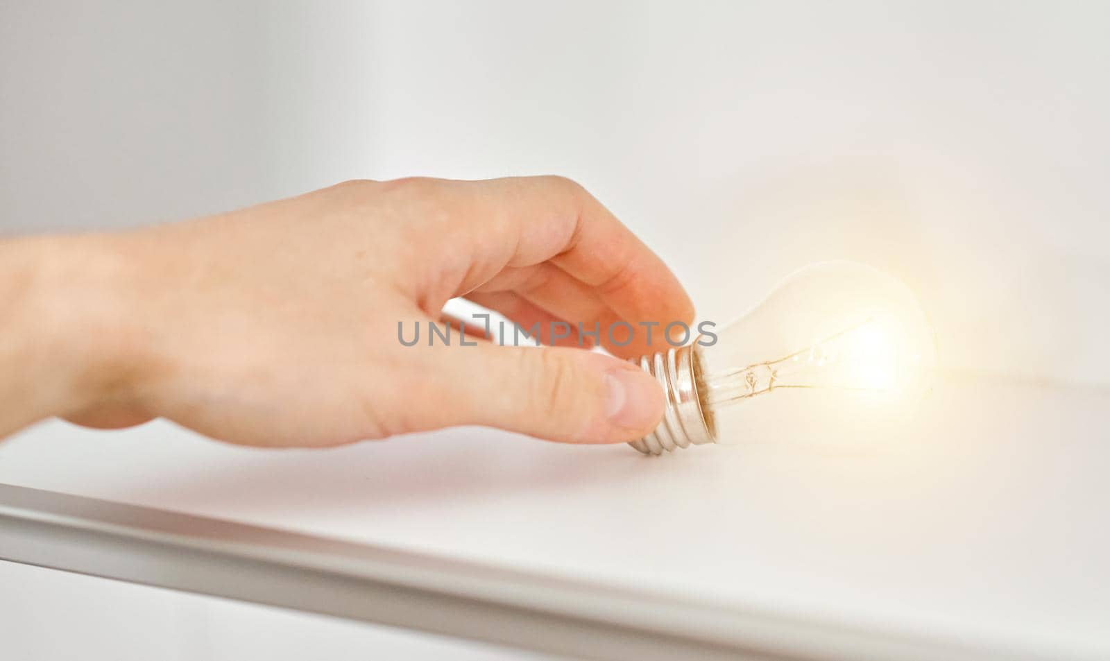 a woman holds an electric lamp that shines with warm light. The concept of a new idea. High quality photo