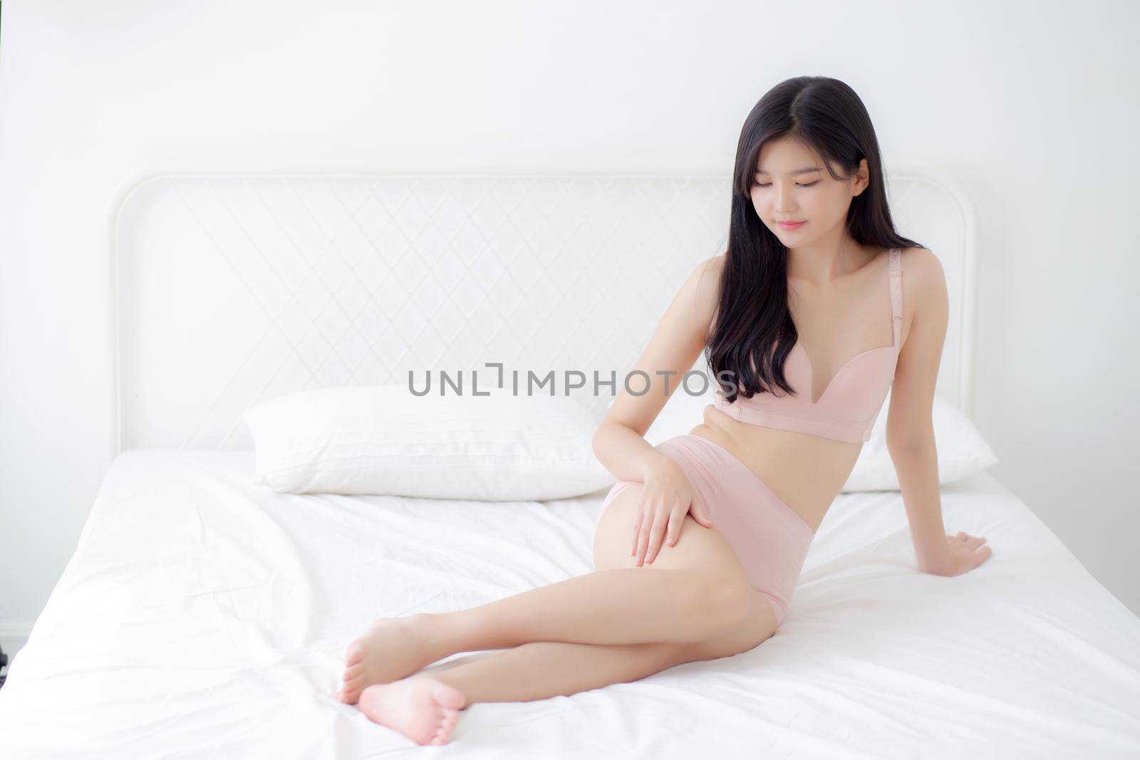Beautiful young asian woman touch skin leg smooth with cream and lotion for hydration and smooth, girl applying body care and cosmetic for silky and soft, beauty perfect with wellness, health and care. by nnudoo
