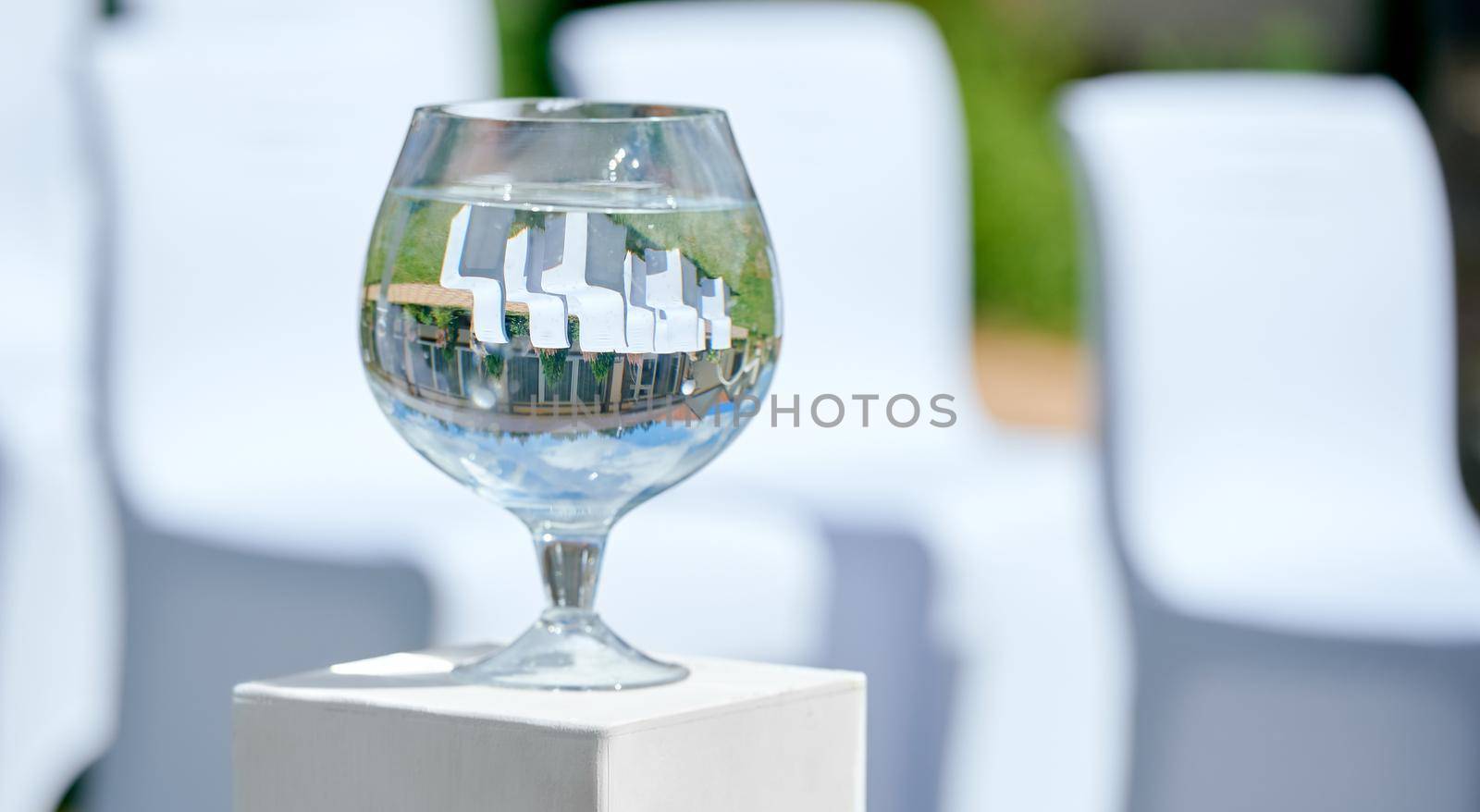 Wine Bacal vase on stand with upside-down image of the background. High quality photo