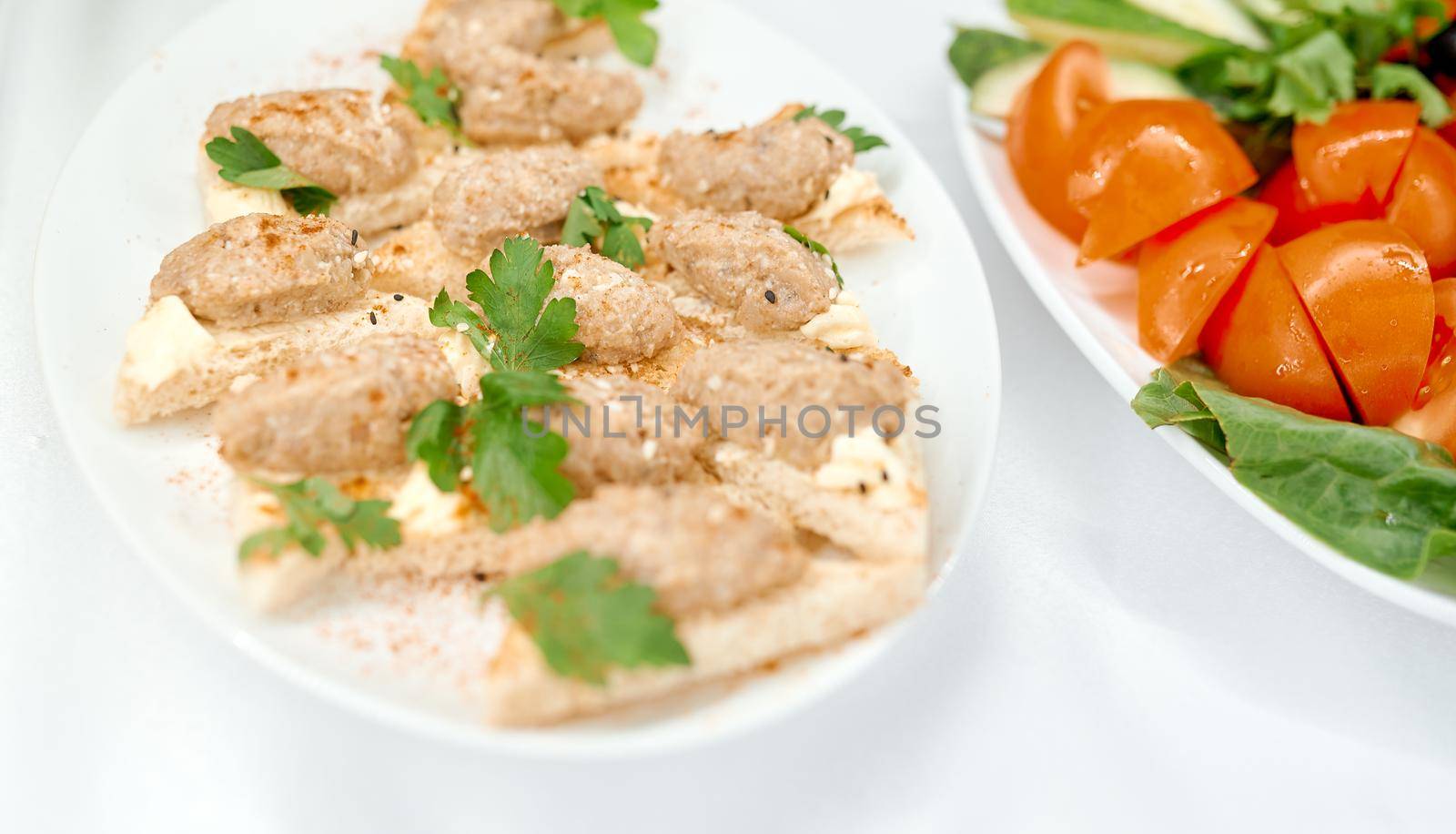 Open sandwiches with meatballs fried meat next to tomatoes . High quality photo