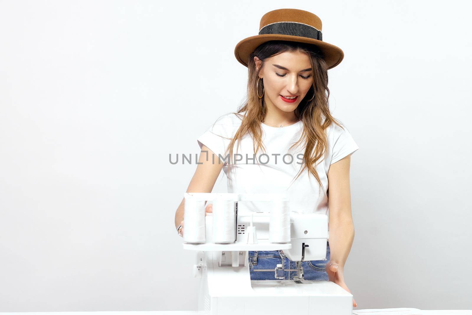 Smiling Girl with sewing machine poses for photo High quality photo