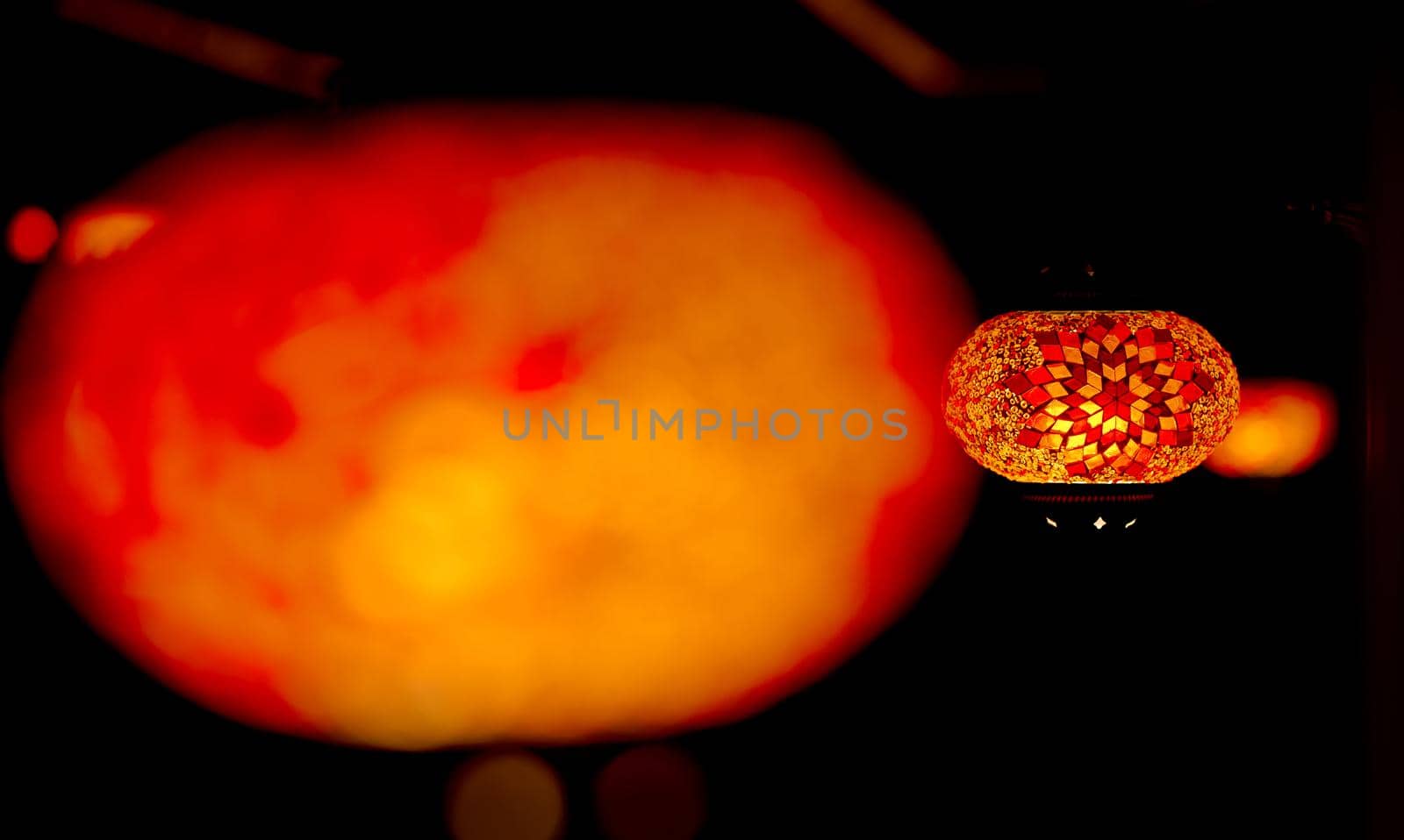 traditional orange lamp from pieces of Glass blurred first sharp second. High quality photo