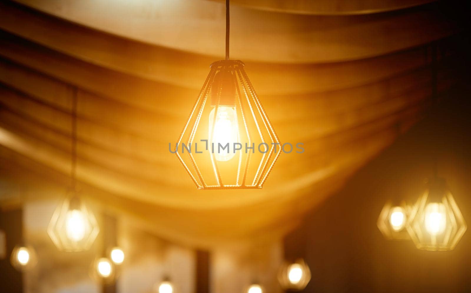 ceiling lamps made of rebar under a curved wooden ceiling. High quality photo