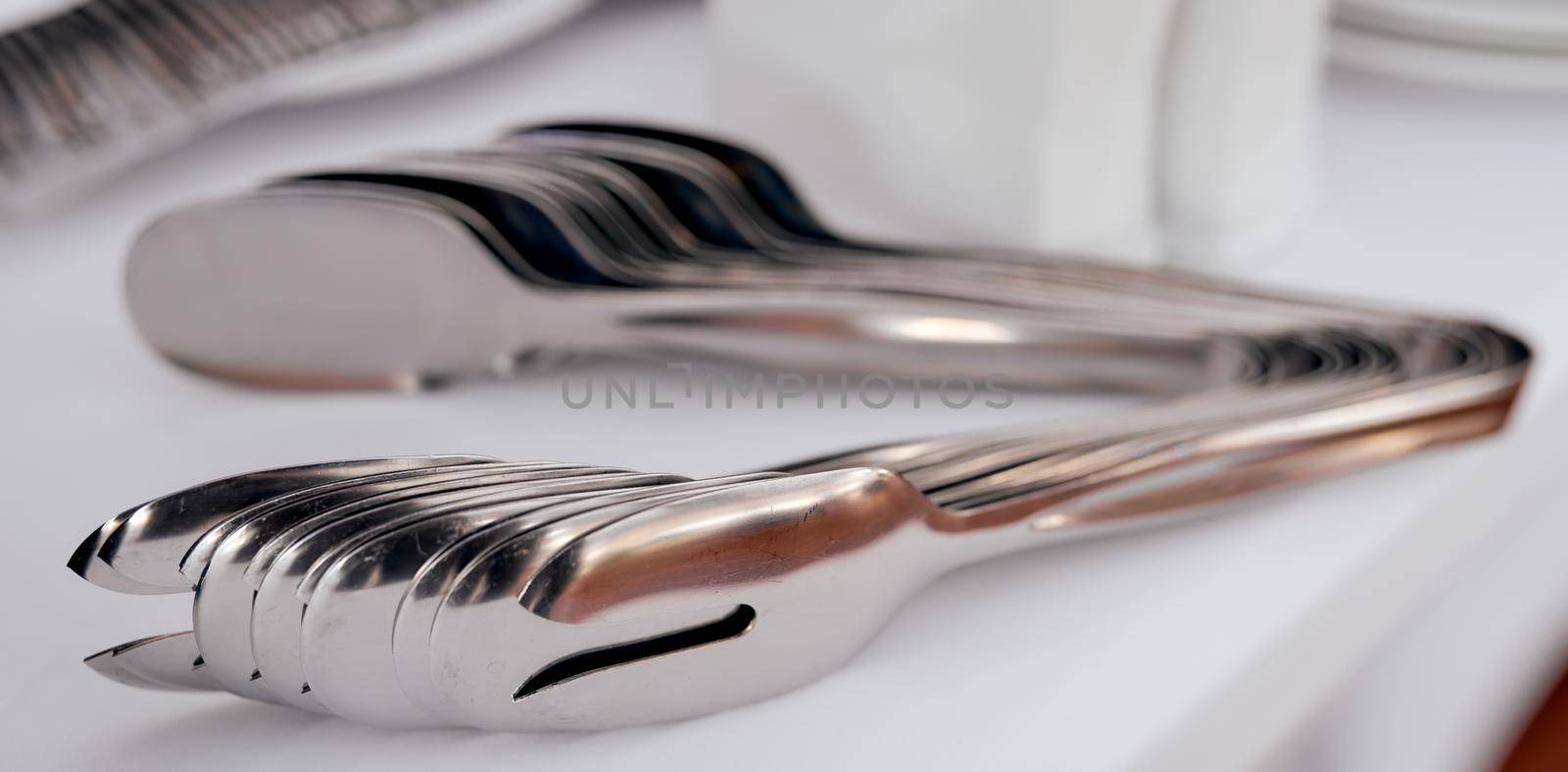 many food tongs on white table in each other. High quality photo