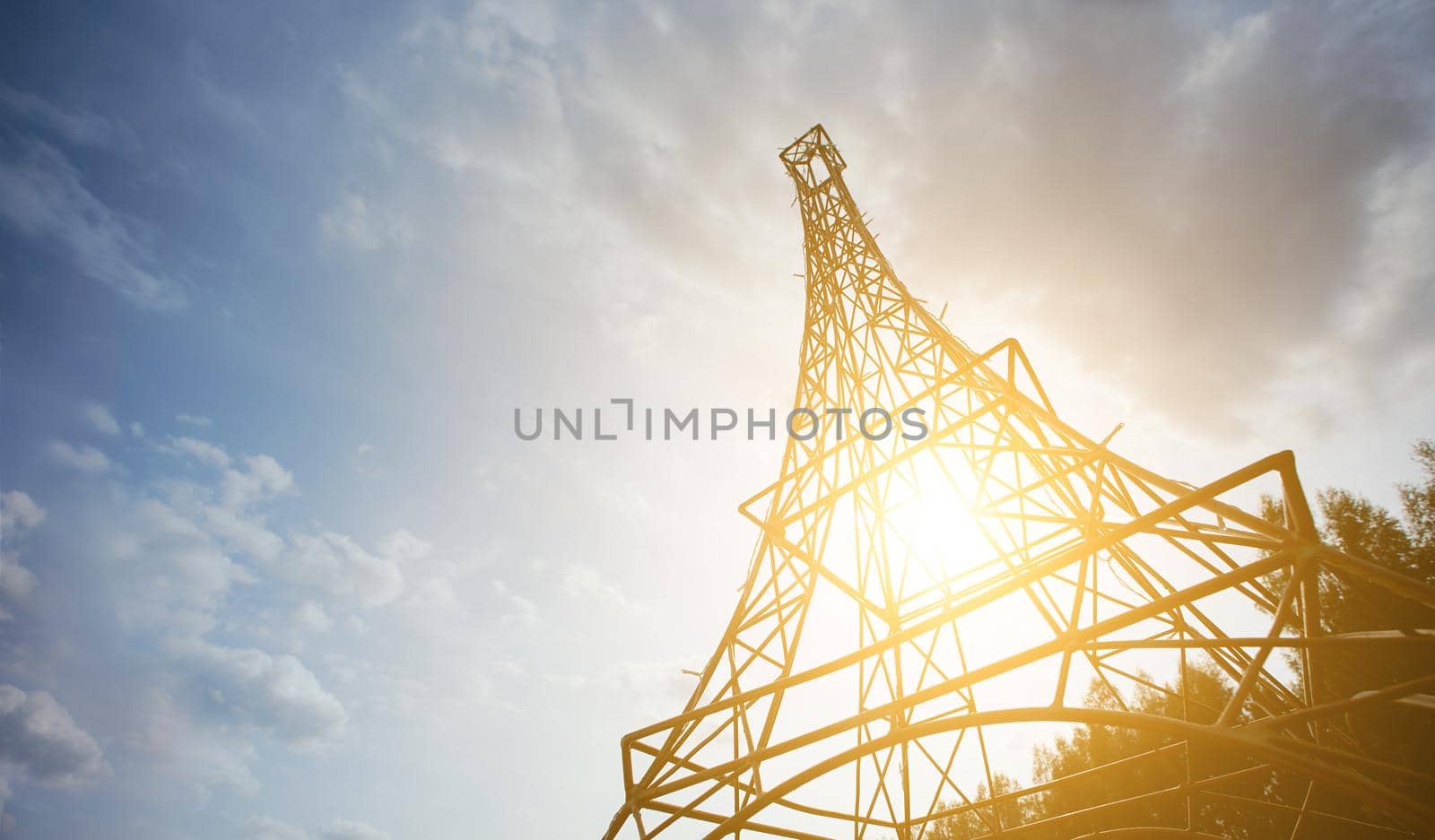 Model of the Eiffel tower in sunny weather from below with sky on background. High quality photo