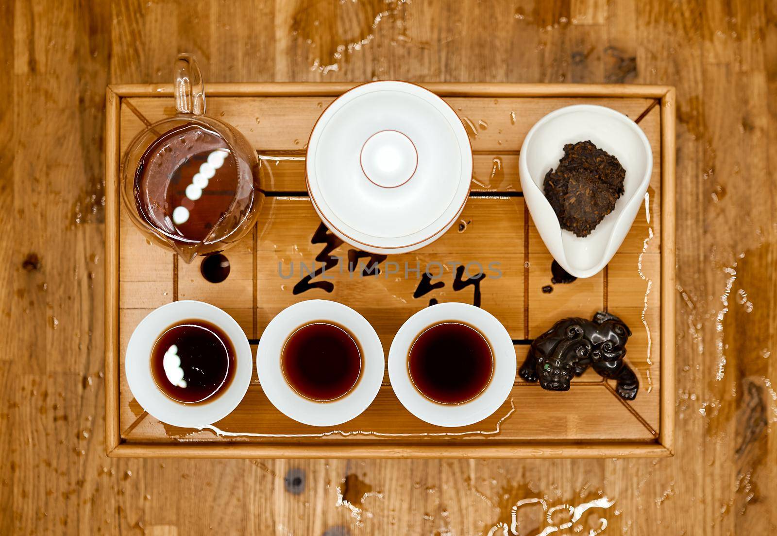Chinese traditional tea tray with dragon on tray and filled kettle cups top shoot . High quality photo
