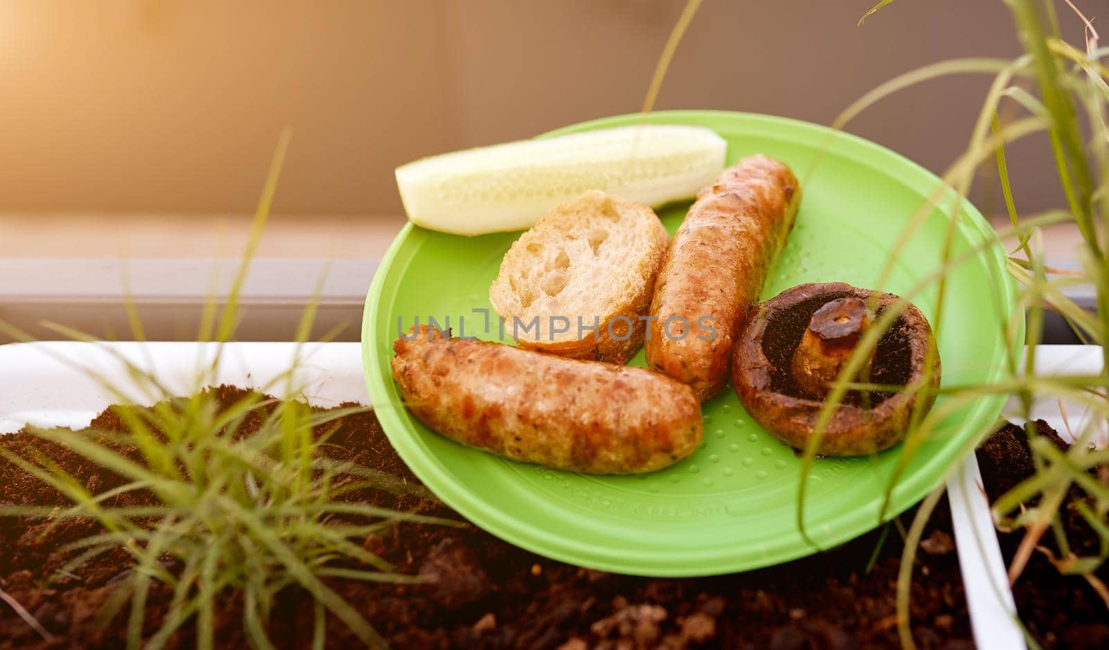 fried sausages mushroom bread on disposable plate nature picnic . High quality photo