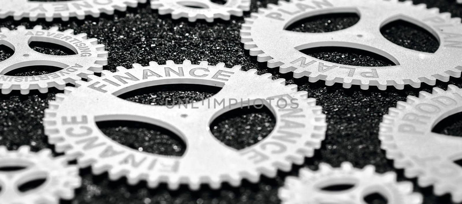 several gears with different inscription. topic of finance. in focus finance plan by AntonIlchanka