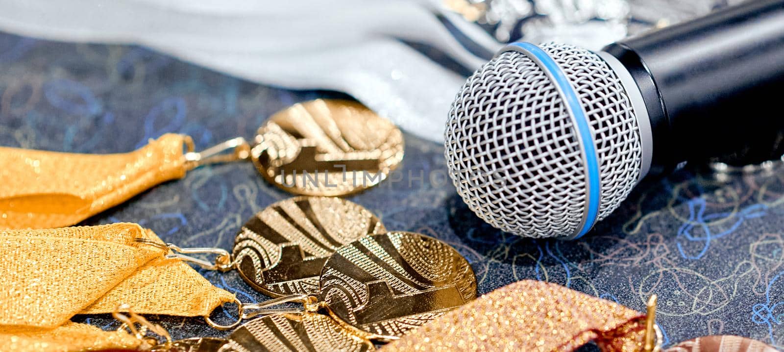 Awards, medals with ribbons on the table with a microphone . High quality photo