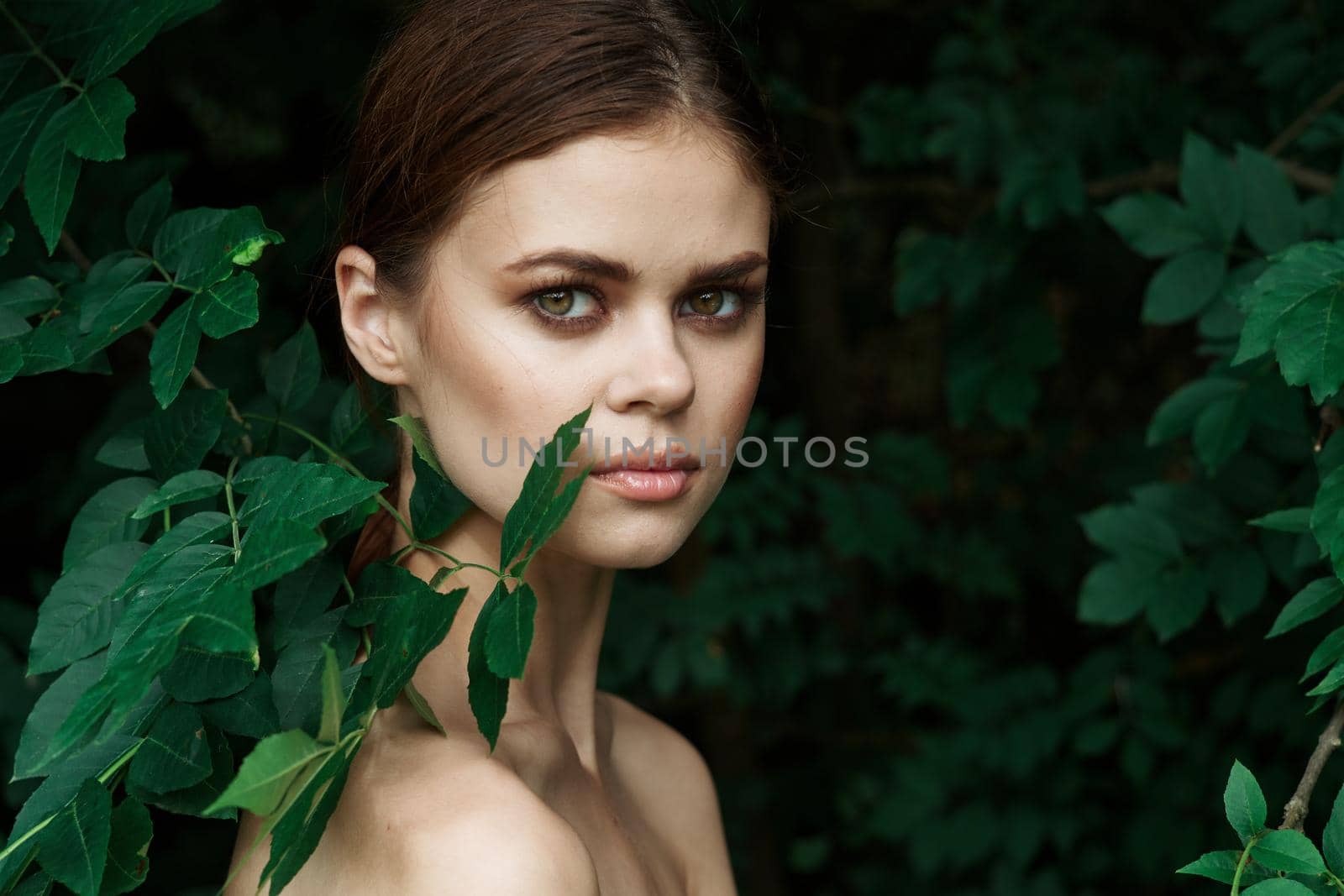 portrait of a woman green leaves clean skin nature summer close-up. High quality photo