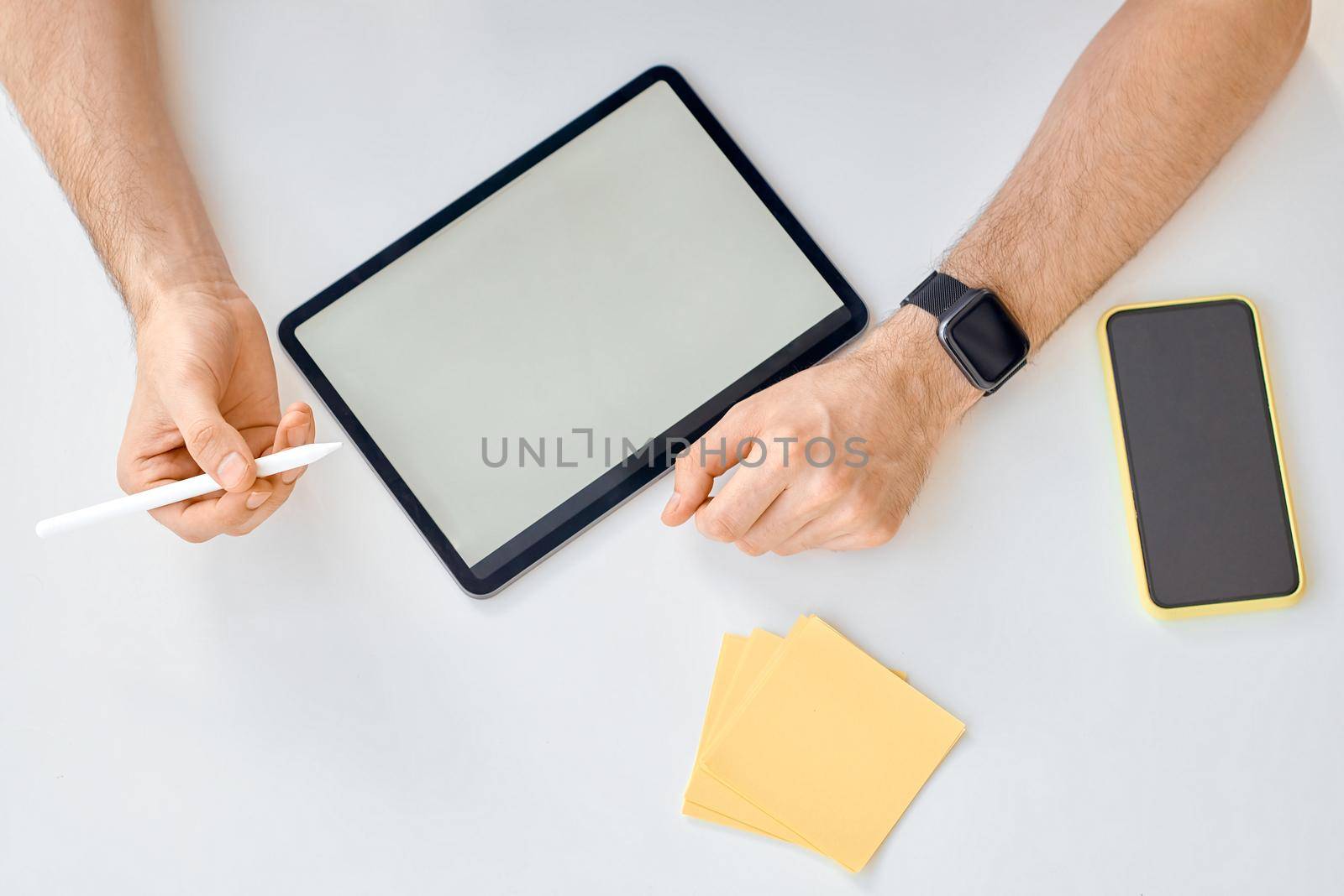 Man ready to write draw on tablet on white phone stickers. High quality photo