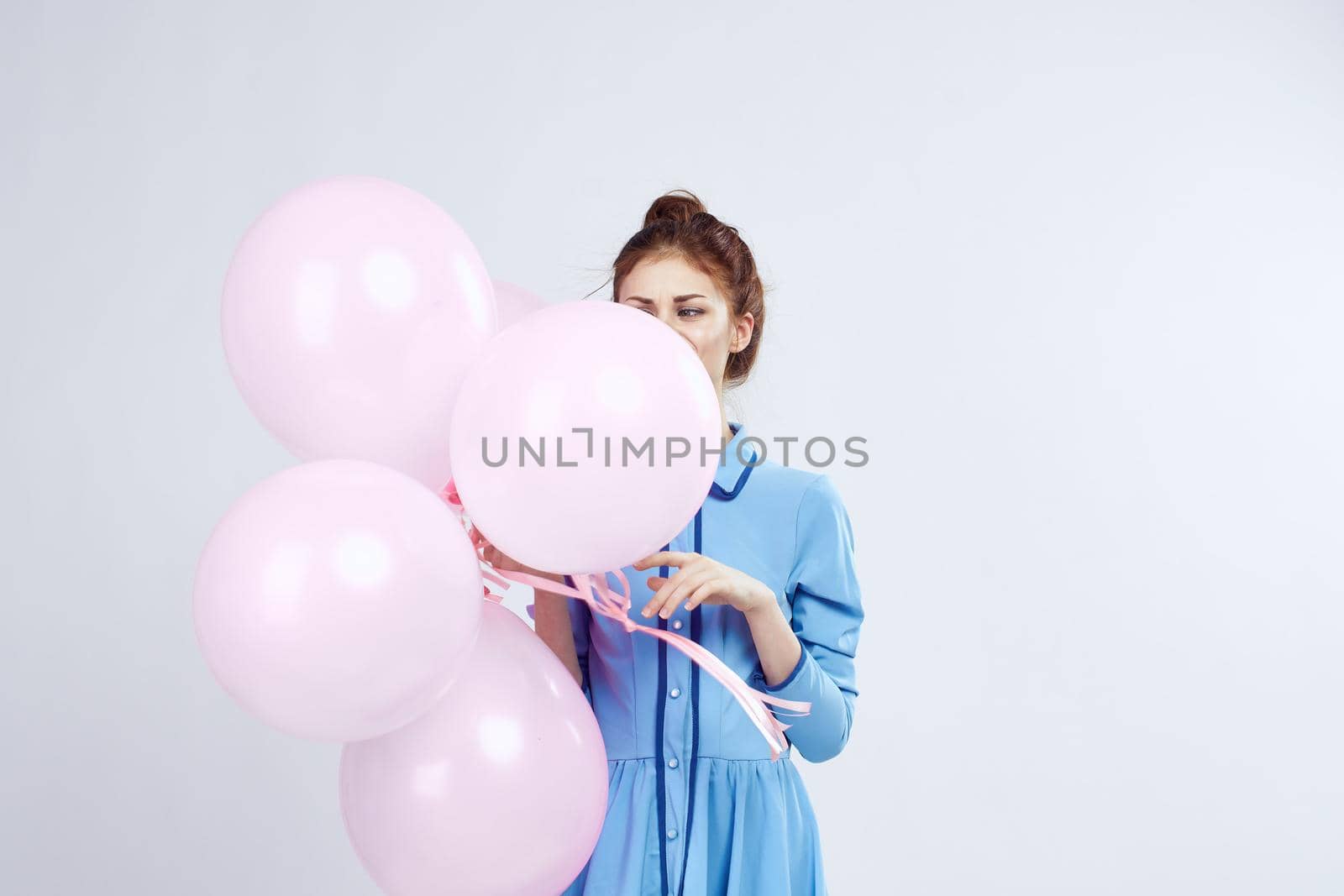 cheerful woman in a blue dress pink balloons holiday birthday by Vichizh