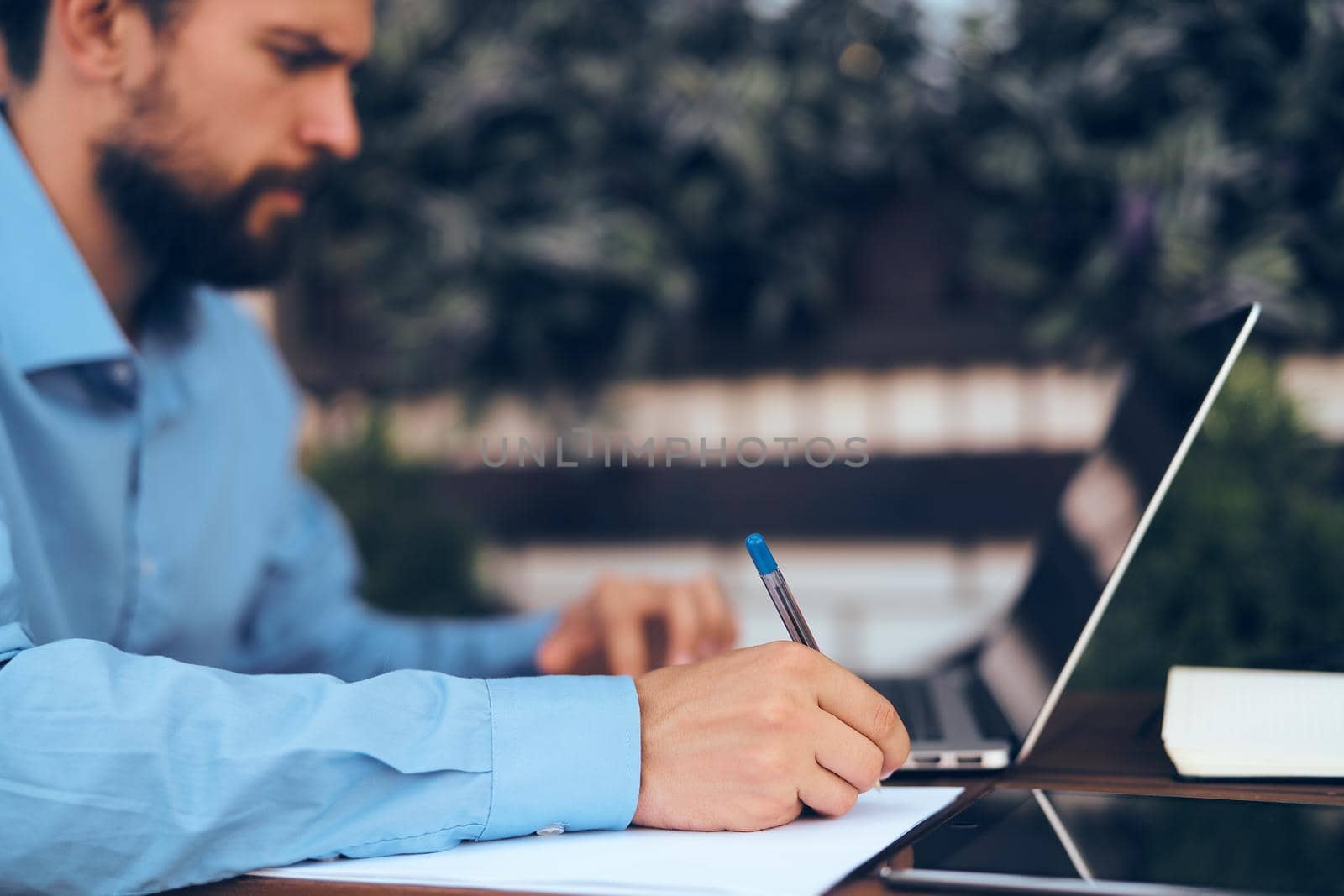 business man working on laptop outdoors. High quality photo