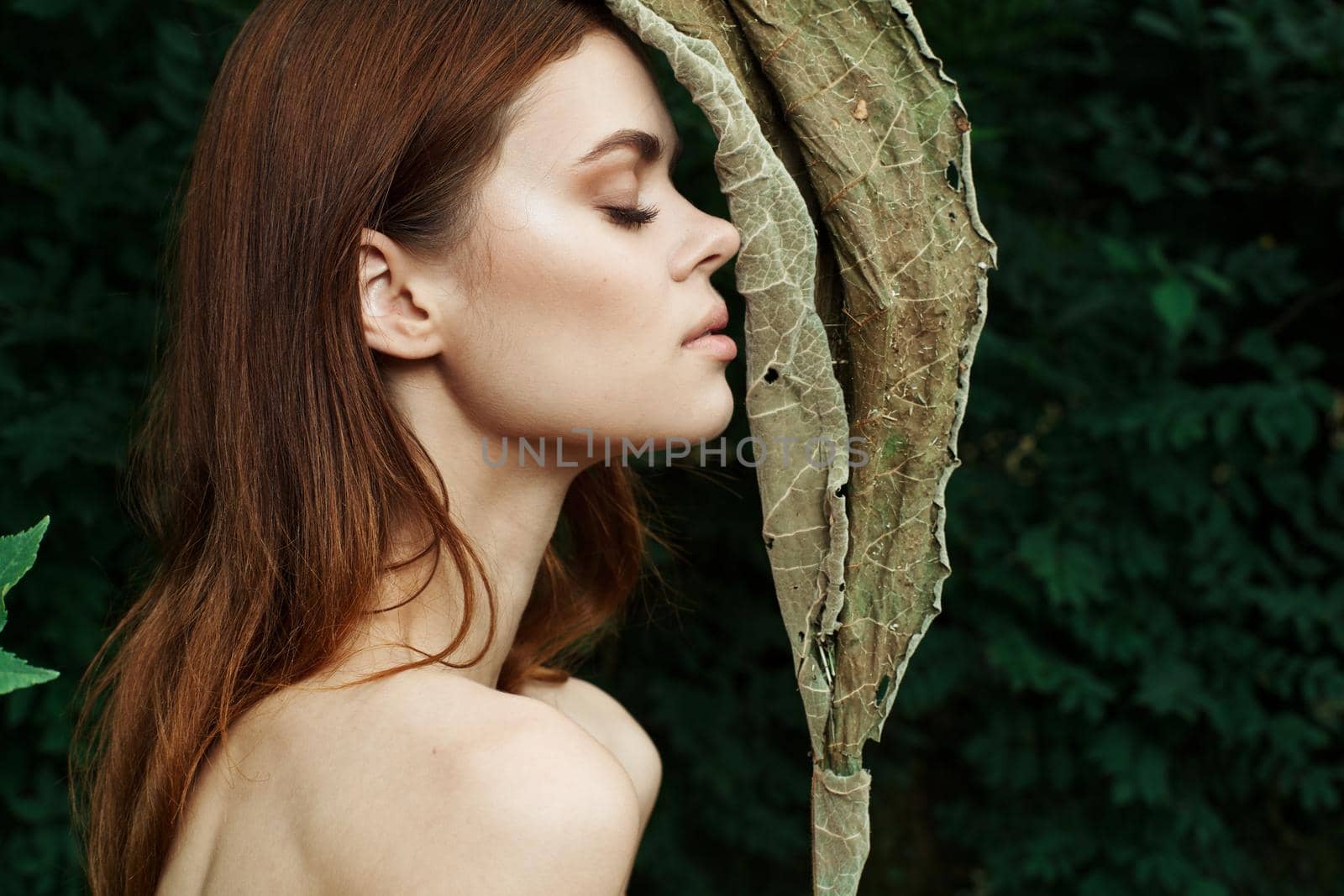 pretty woman Cosmetology nature green leaves glamor cropped view. High quality photo