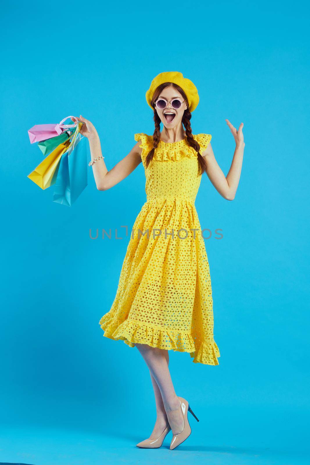 cheerful woman with multicolored bags posing isolated background by Vichizh