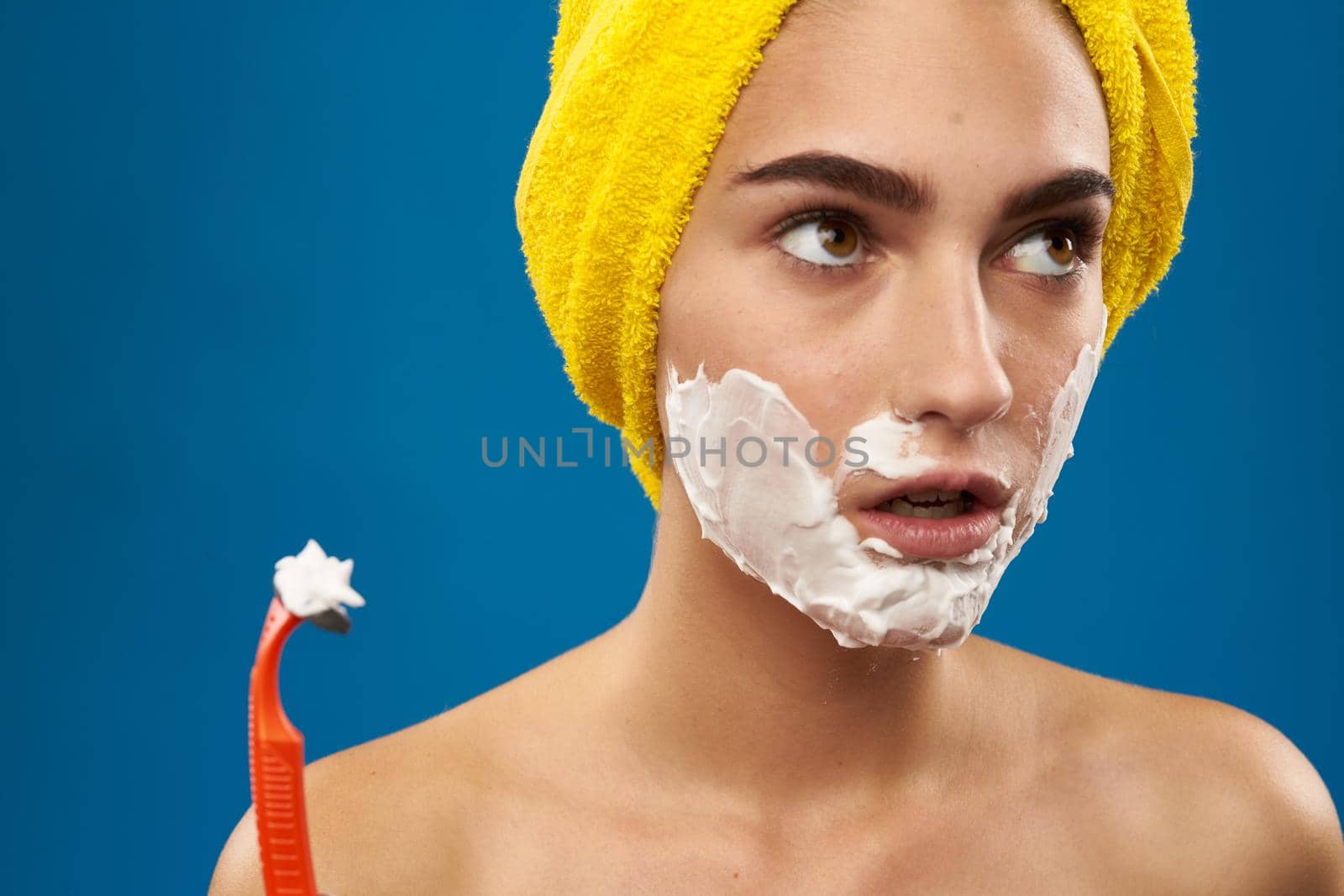 pretty woman razor in hand skin care hygiene blue background by Vichizh