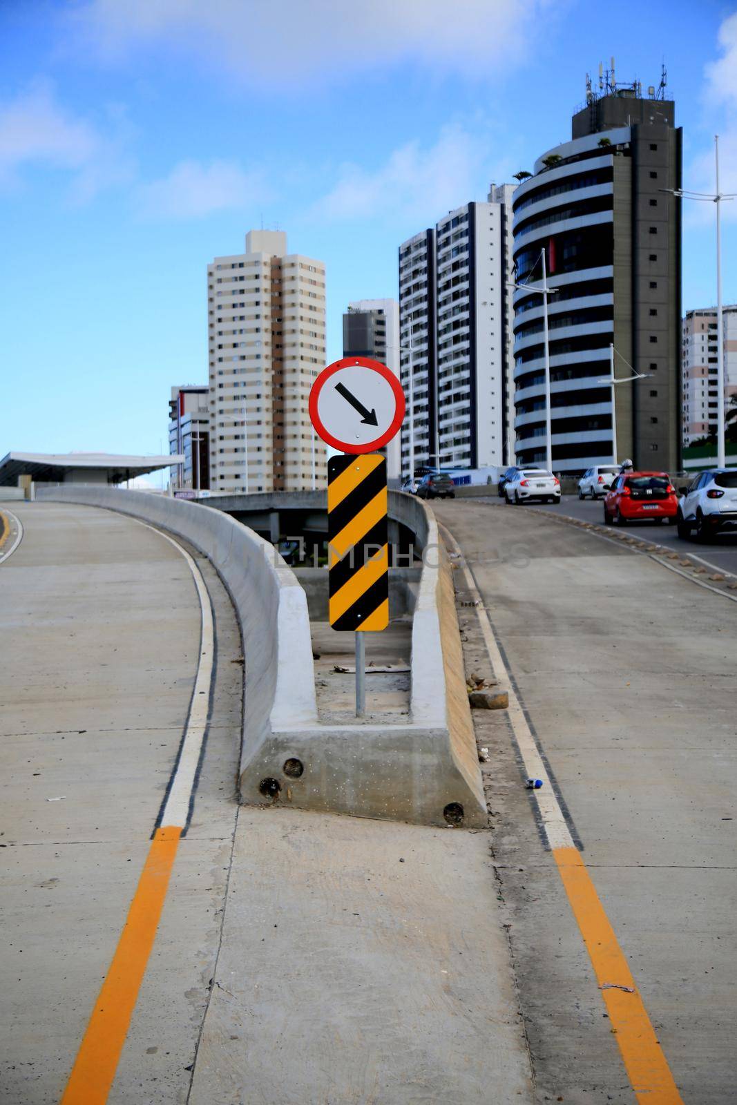 salvador, bahia, brazil - july 20, 2021: Traffic sign indicates mandatory crossing and zebra stripe indicates obstacle and danger marker on a traffic lane in the city of Salvador.