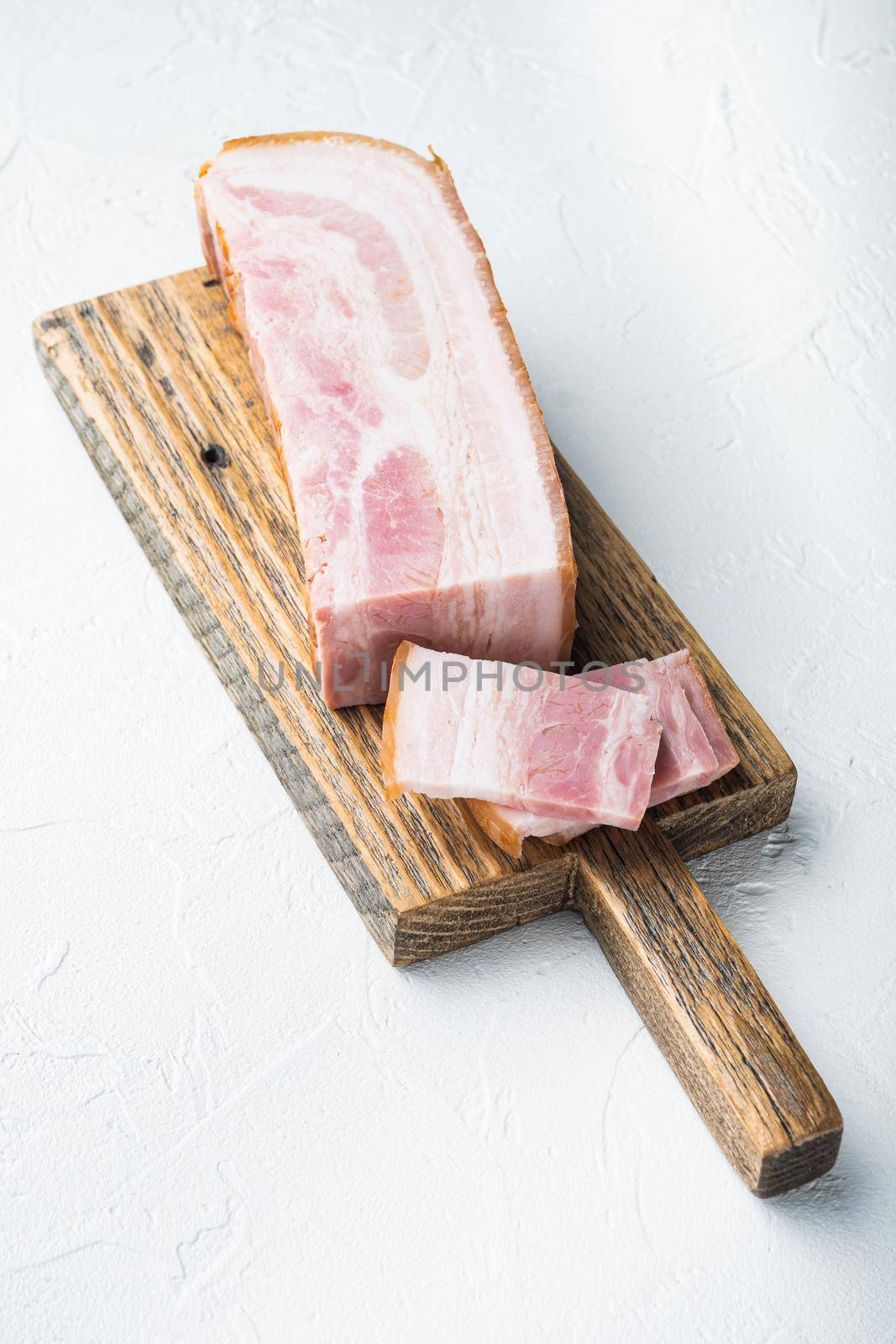 Bacon pancetta cut and sliced on white background by Ilianesolenyi