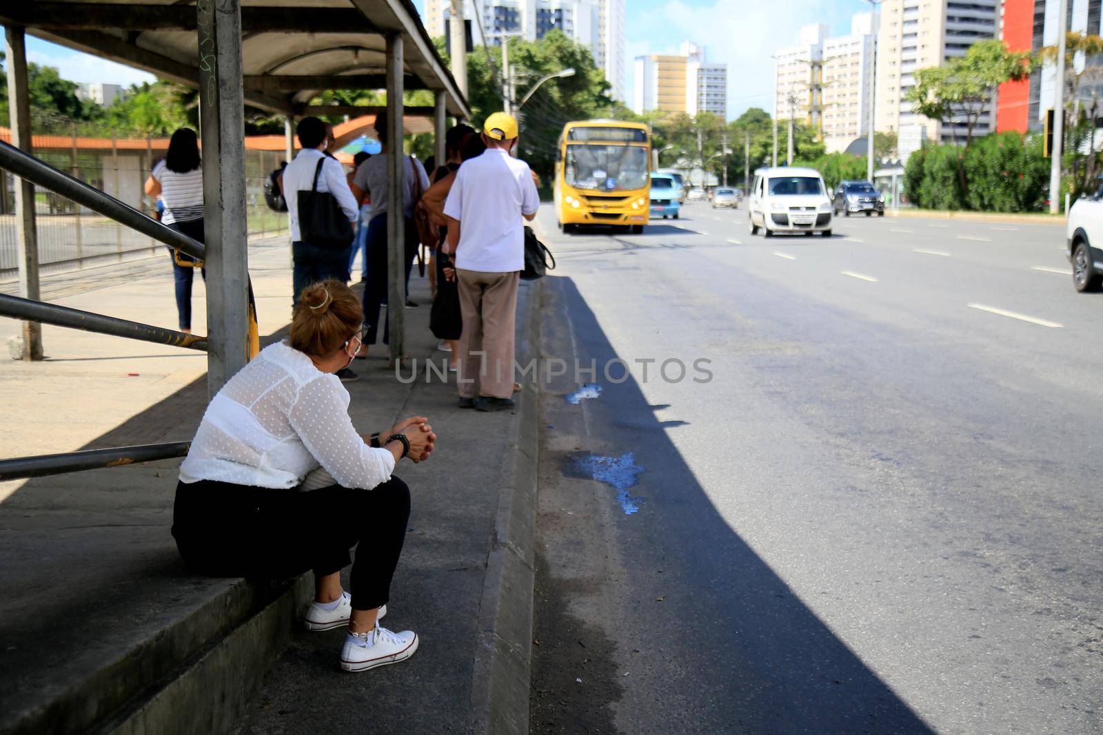 salvador, bahia, brazil - july 20, 2021: passengers are seen waiting for public transport buses at a bus stop in the city of Salvador.