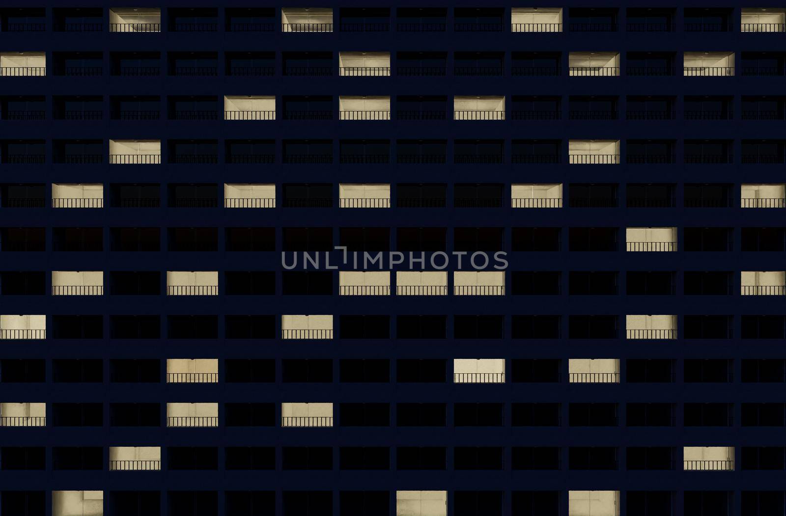 building facade at night with some rooms illuminated. 3d rendering