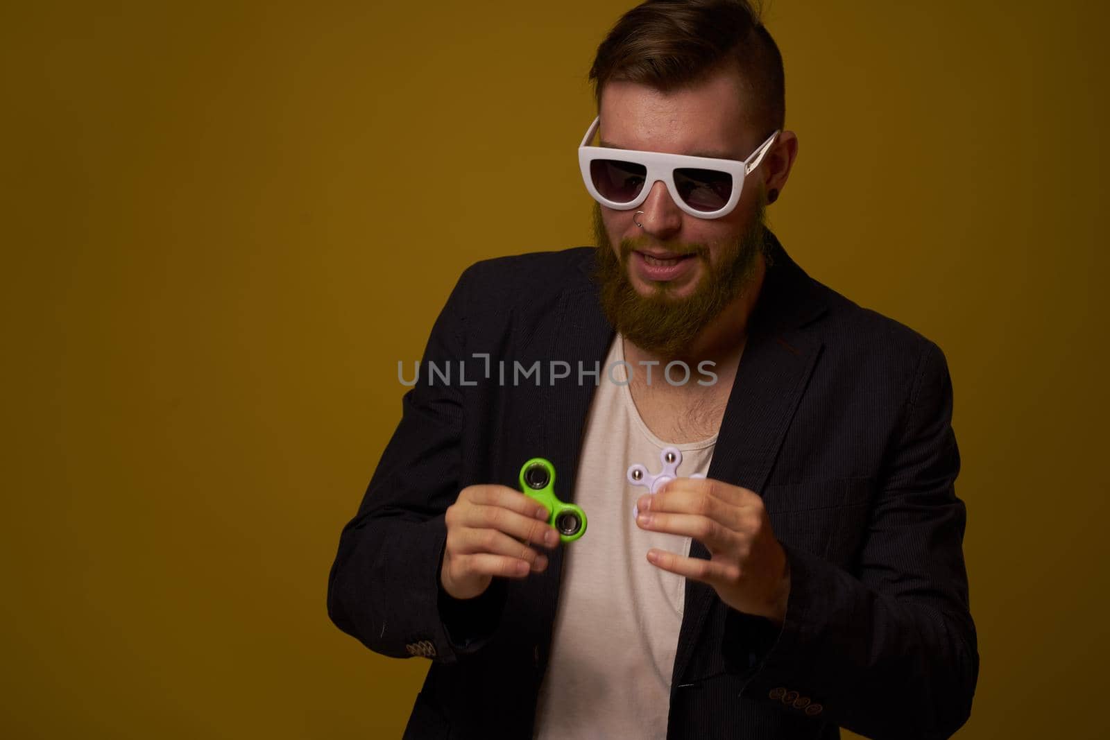 man wearing sunglasses spinner in hands fashion posing black jacket. High quality photo