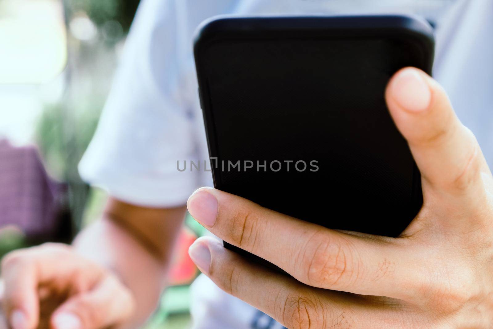 Close up image of a man using mobile smart phone