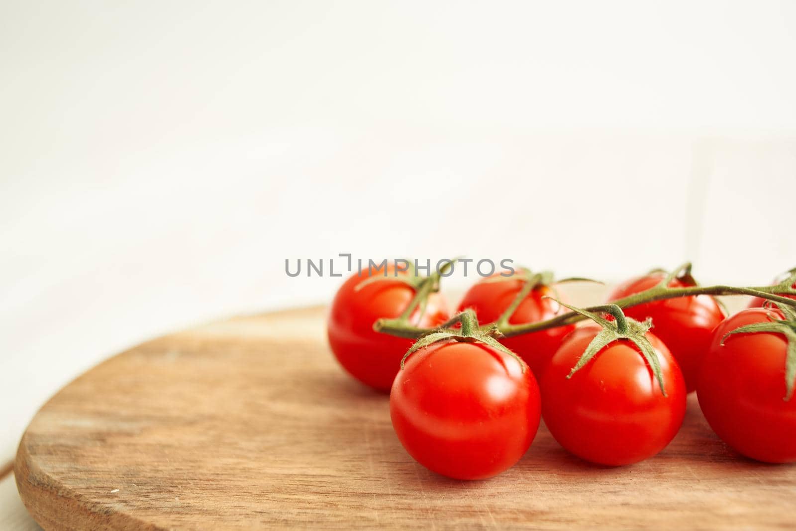 Ingredients Cherry tomatoes on a cutting board wood background. High quality photo