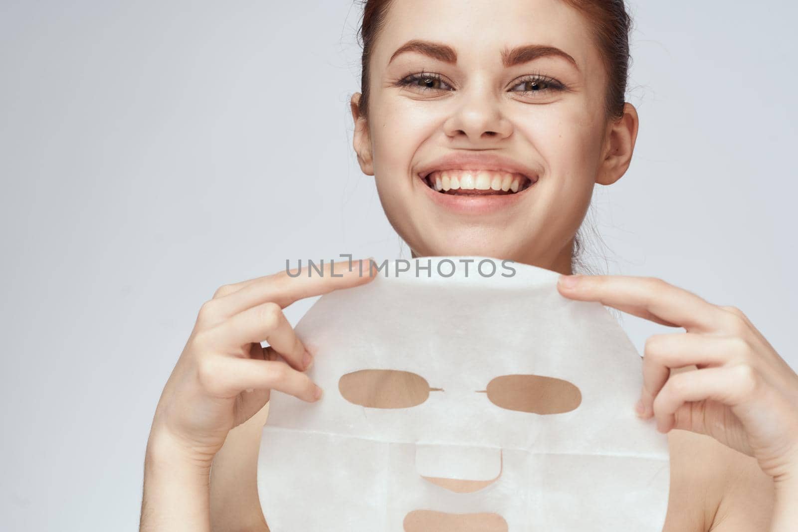 woman with mask in hands skin care rejuvenation spa treatments by Vichizh