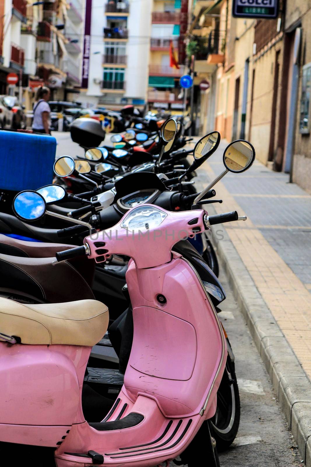 Alicante, Spain- October 9, 2021: Row of motorcycles parked in a row on the street in Spain