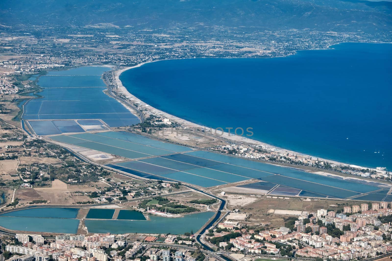 aerial view of (Poetto beach ) seashore of the city of (Cagliari) with salinas field - Sardinia - Italy