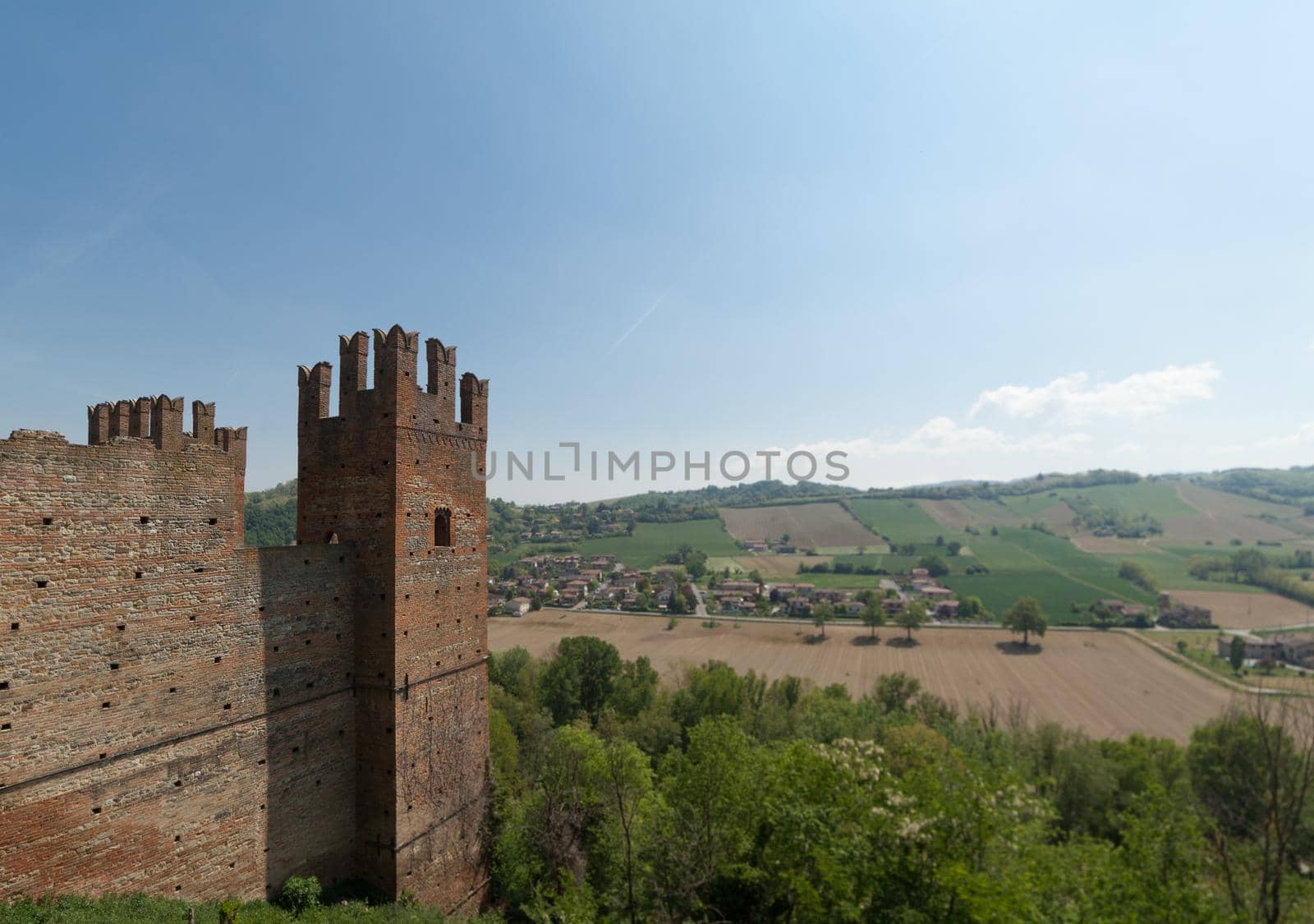 ITALY - APRIL 2017 - View of the historic village of Castell'Arquato with agricultural fields on the background - Visconti Castle in the town of Castell'Arquato