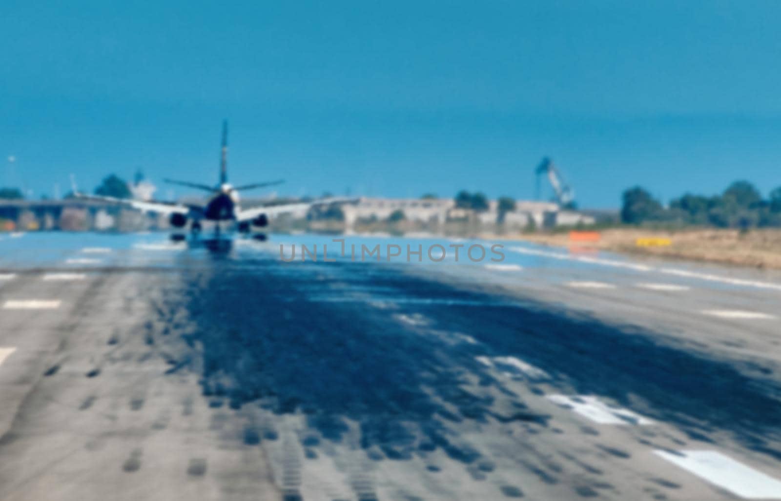 blurred image of airplane taking off from airport line - copy space