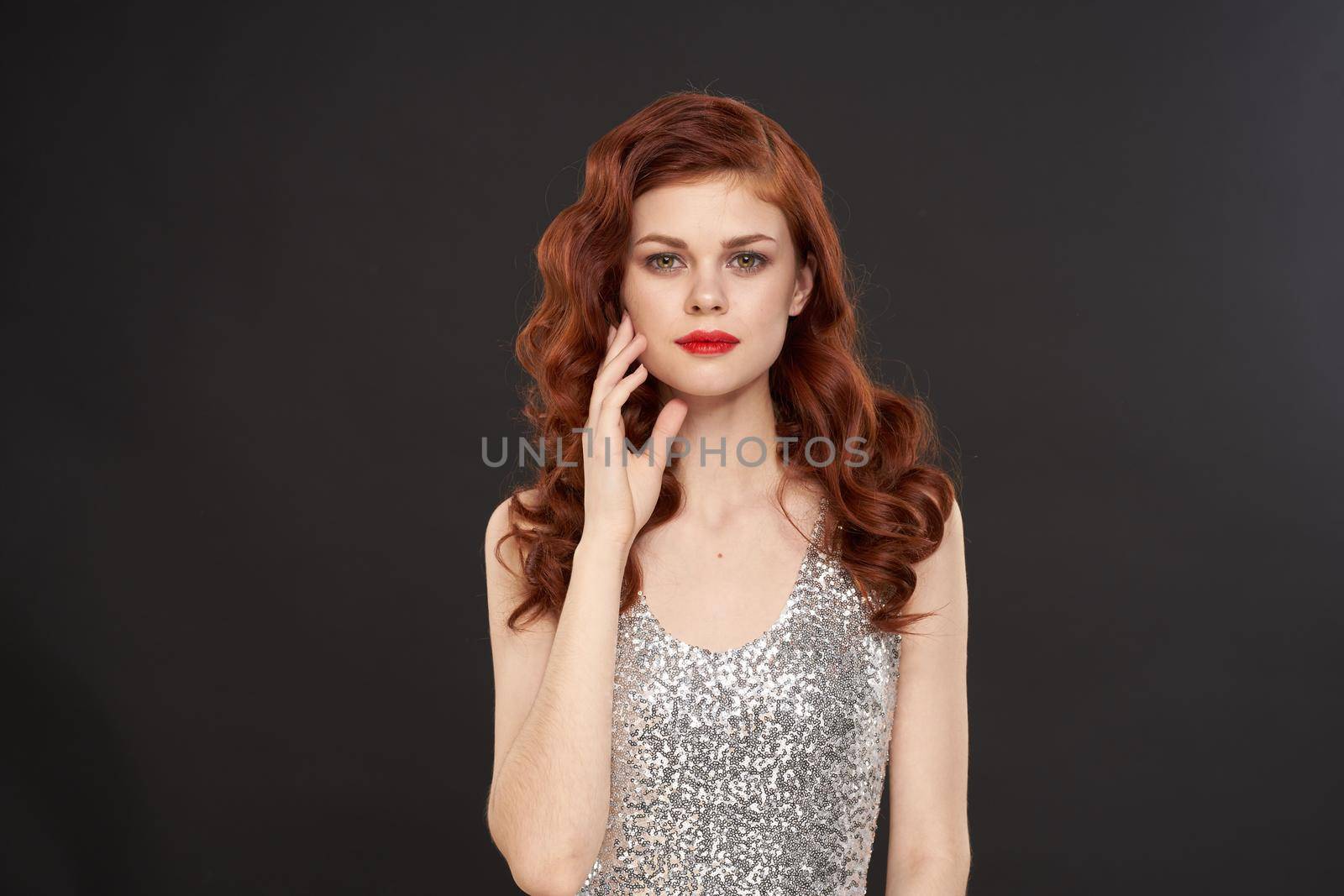 red-haired woman bright makeup glamor posing evening dresses. High quality photo