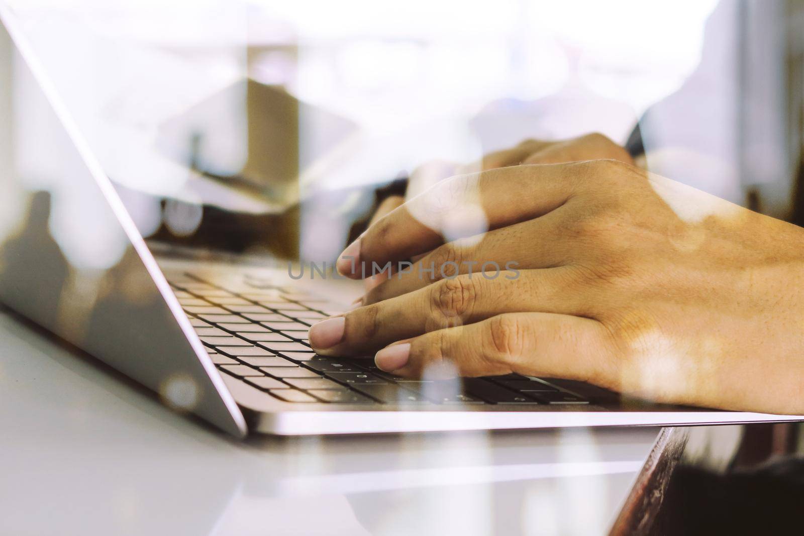 Close up image of Man typing on laptop keyboard