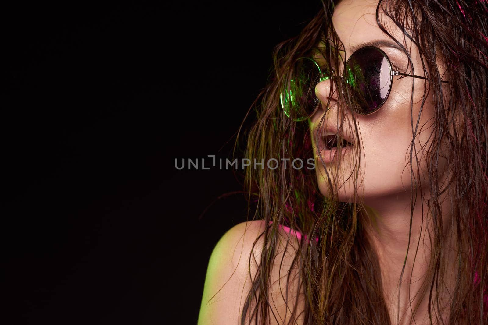 sexy woman wearing sunglasses posing luxury studio lifestyle. High quality photo