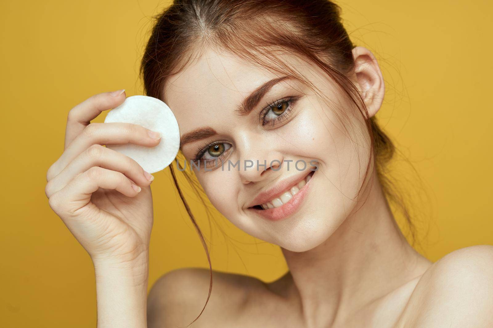 emotional women bare shoulders cotton pads and clear skin attractive look. High quality photo