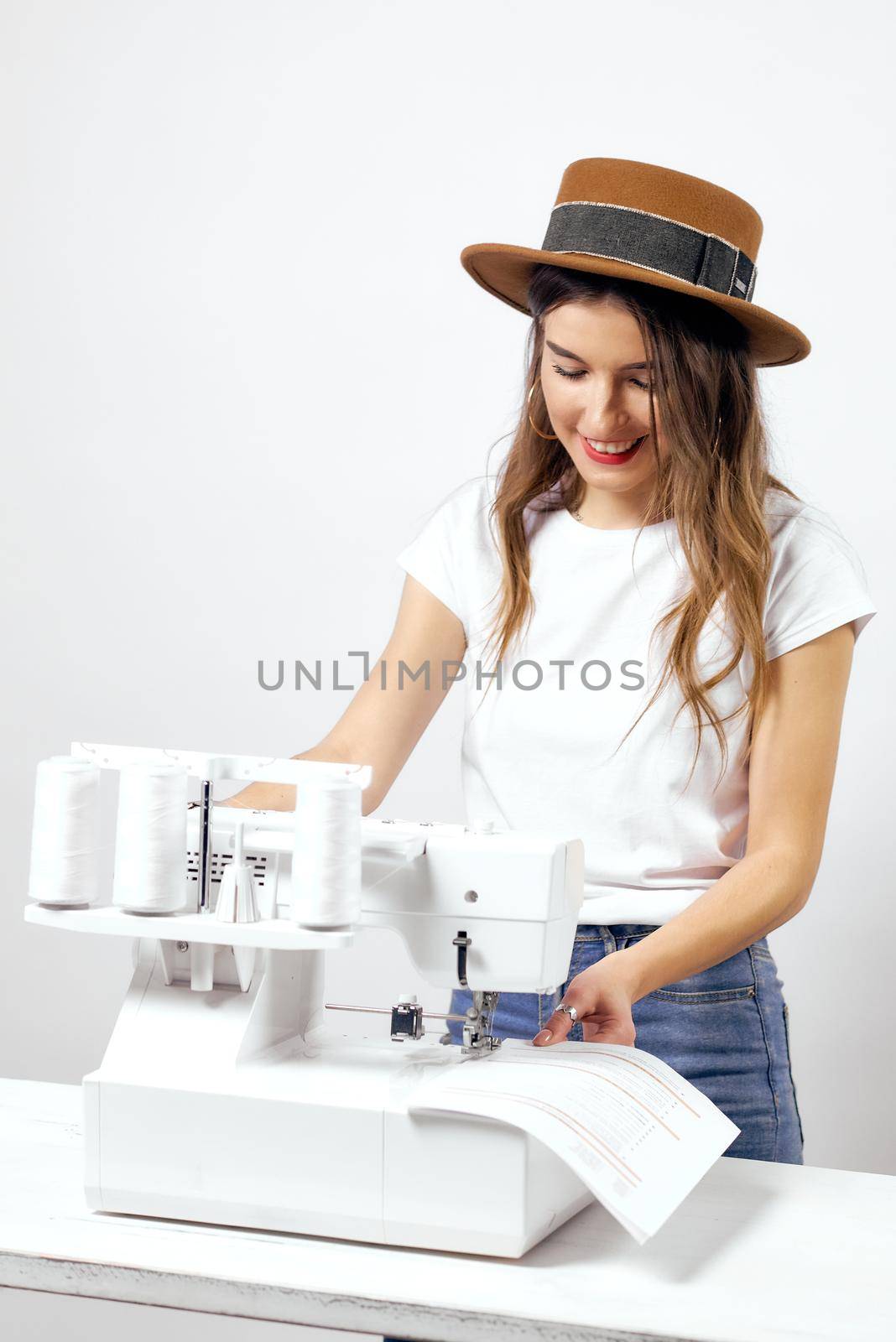 Smiling Girl with sewing machine poses for photo High quality photo