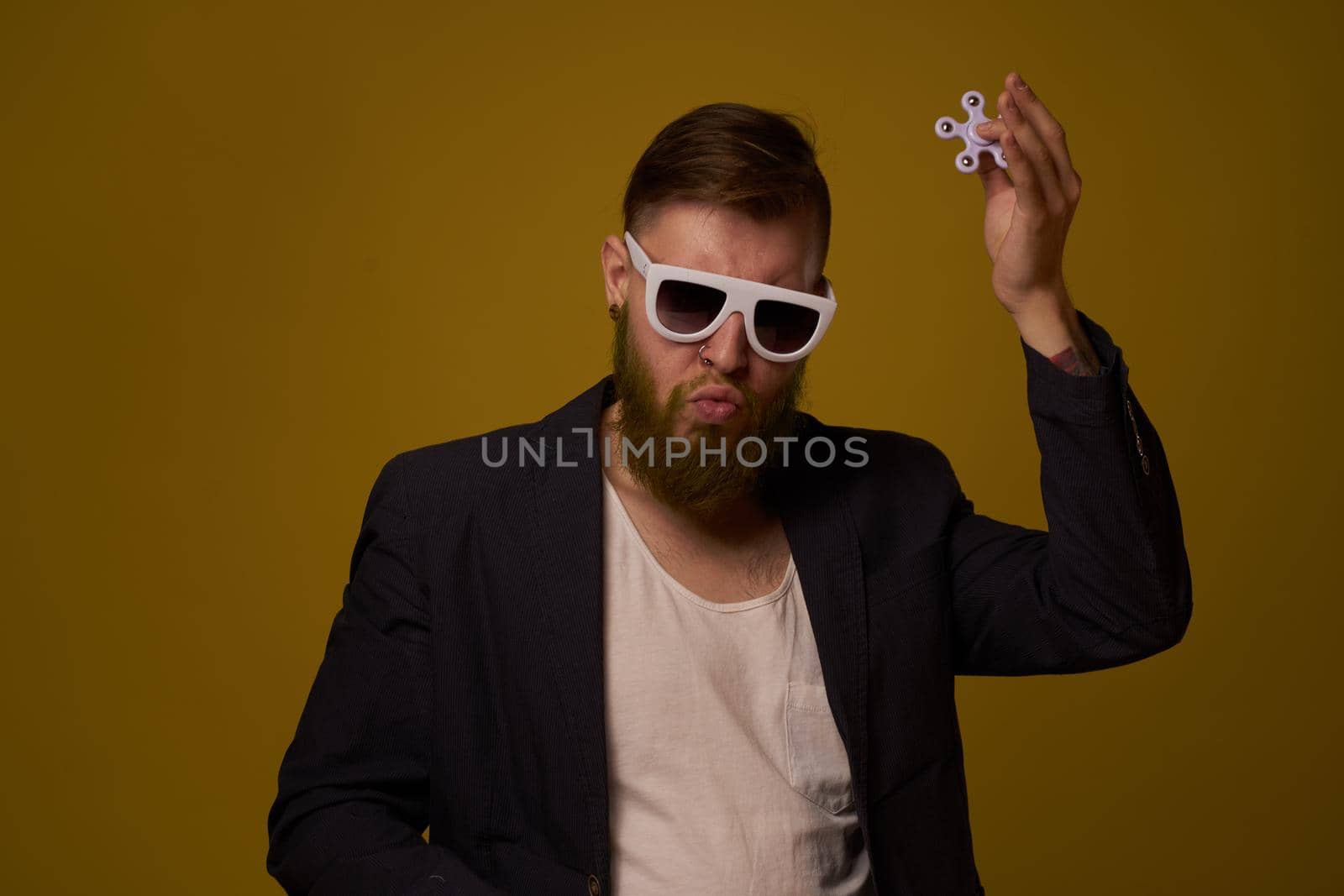 man wearing sunglasses spinner in hands fashion posing black jacket. High quality photo