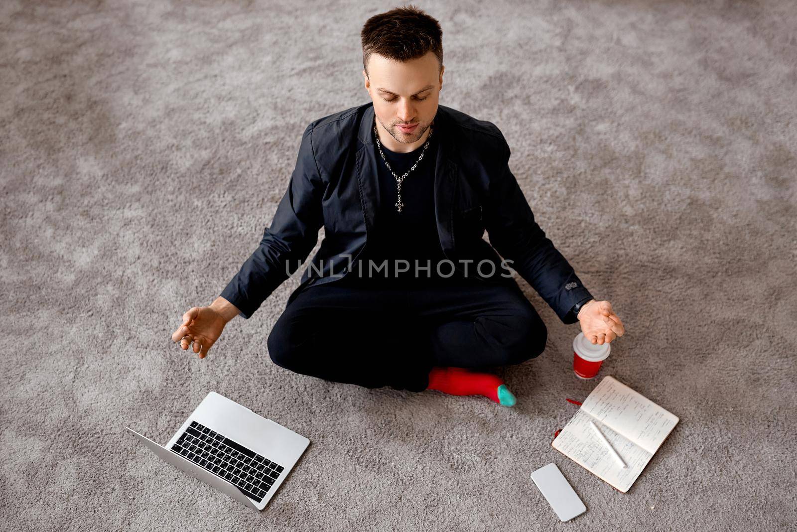 Reflective man with laptop sit in lotus on carper Hight quality