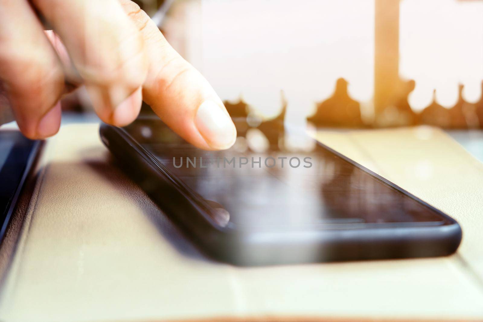 Close up image of a man using mobile smart phone